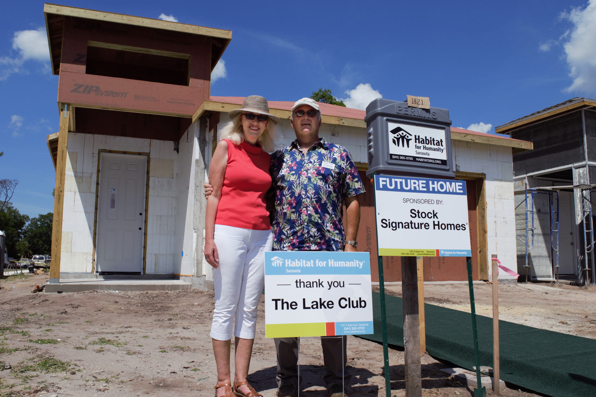 Marybeth and Jay Traverso in front of one of two Hammock Place homes sponsored by Stock Signature Homes in partnership with the Lake Club residents.