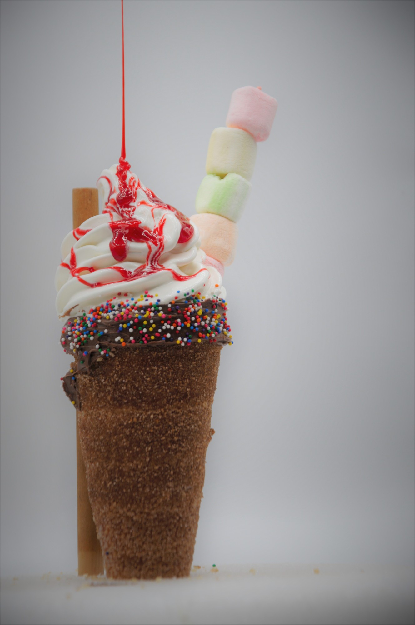The Miami Vanilla ice cream topped with colorful marshmallows, rainbow sprinkles and a berry drizzle. 