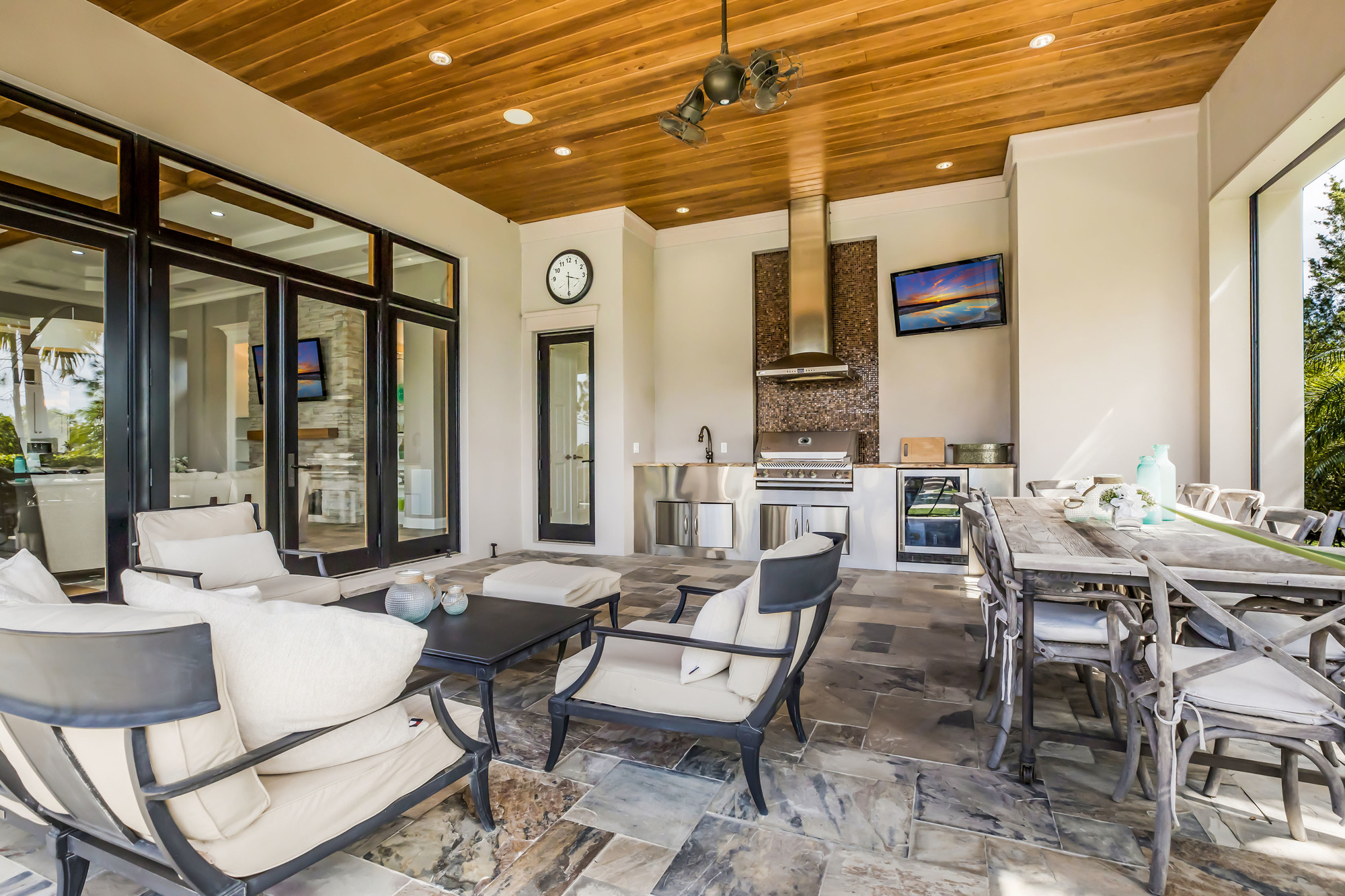 The outdoor living area contains all the comforts of the indoors, including a kitchen, fireplace and television. Screens can be lowered at the touch of a button.