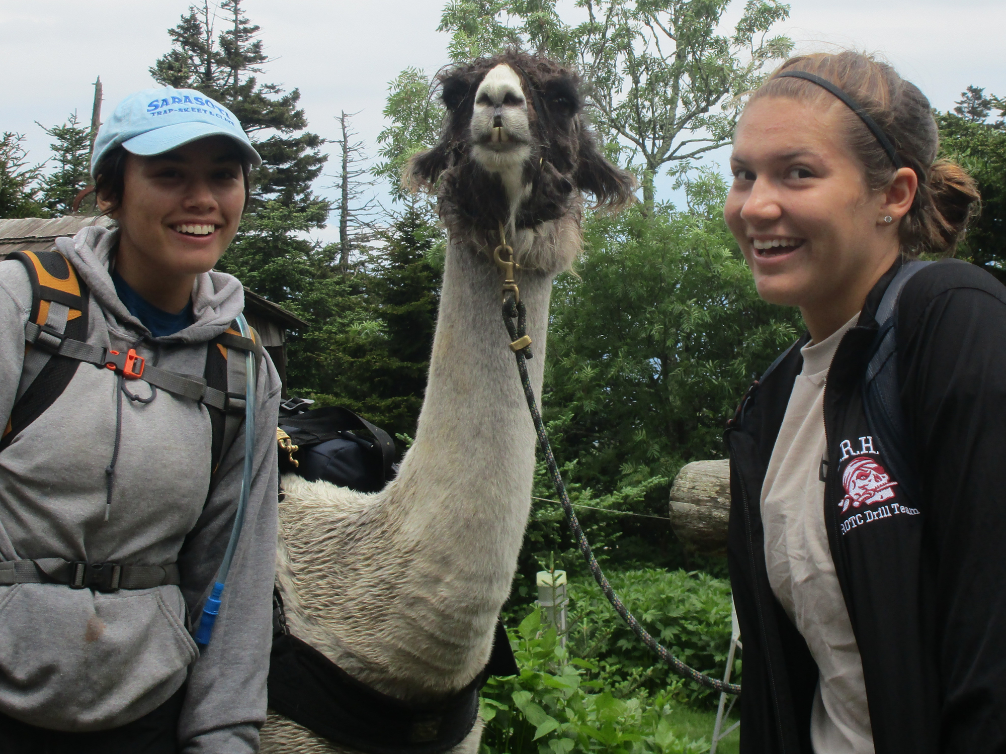Taylore Keesler and Selah Swanson have fun with a pancake-loving llama who carries supplies to Mount LeConte