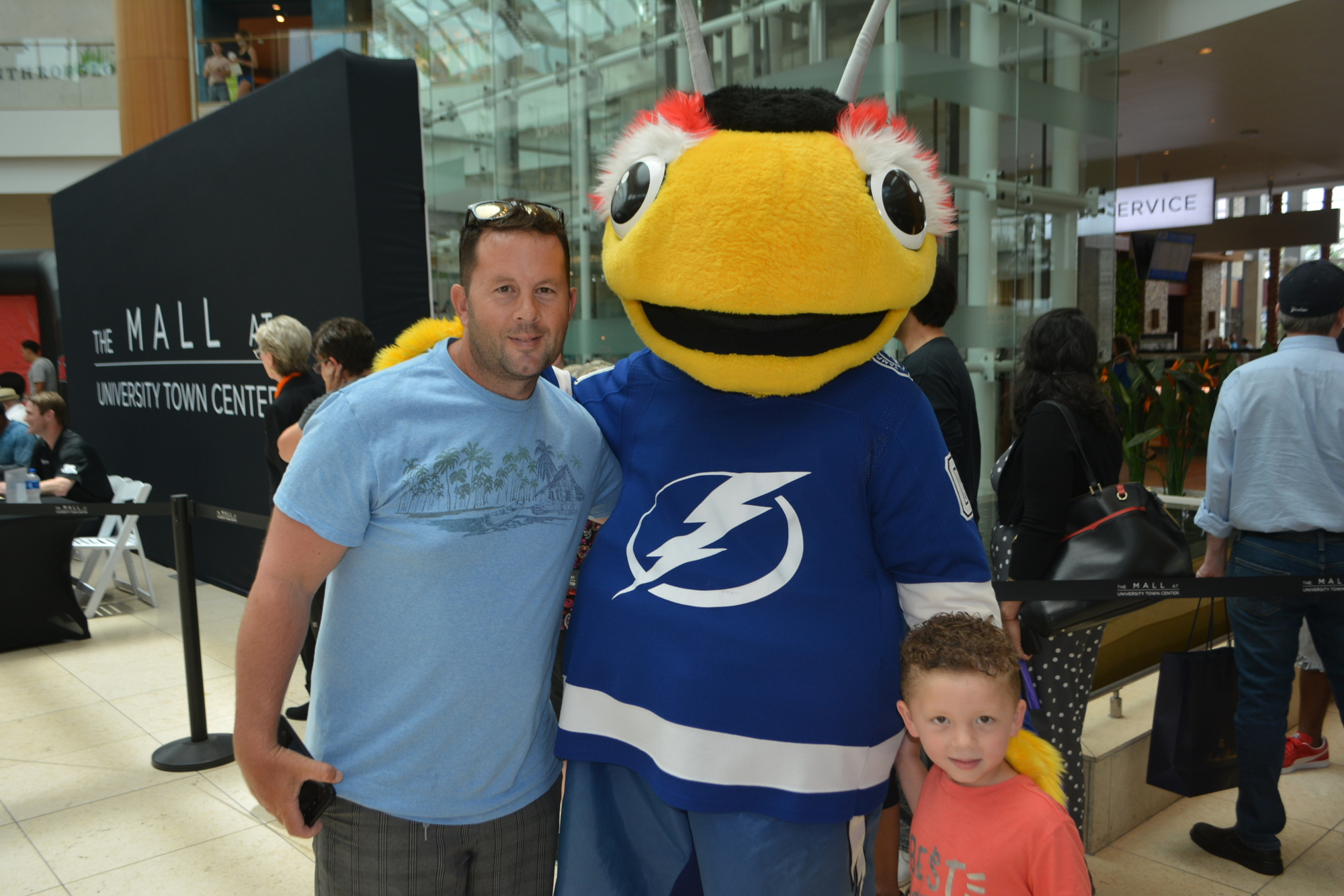 University Park's Vincent Smith and his 4-year-old son, Paxton, had fun meeting Thunderbug, the Lightning mascot.