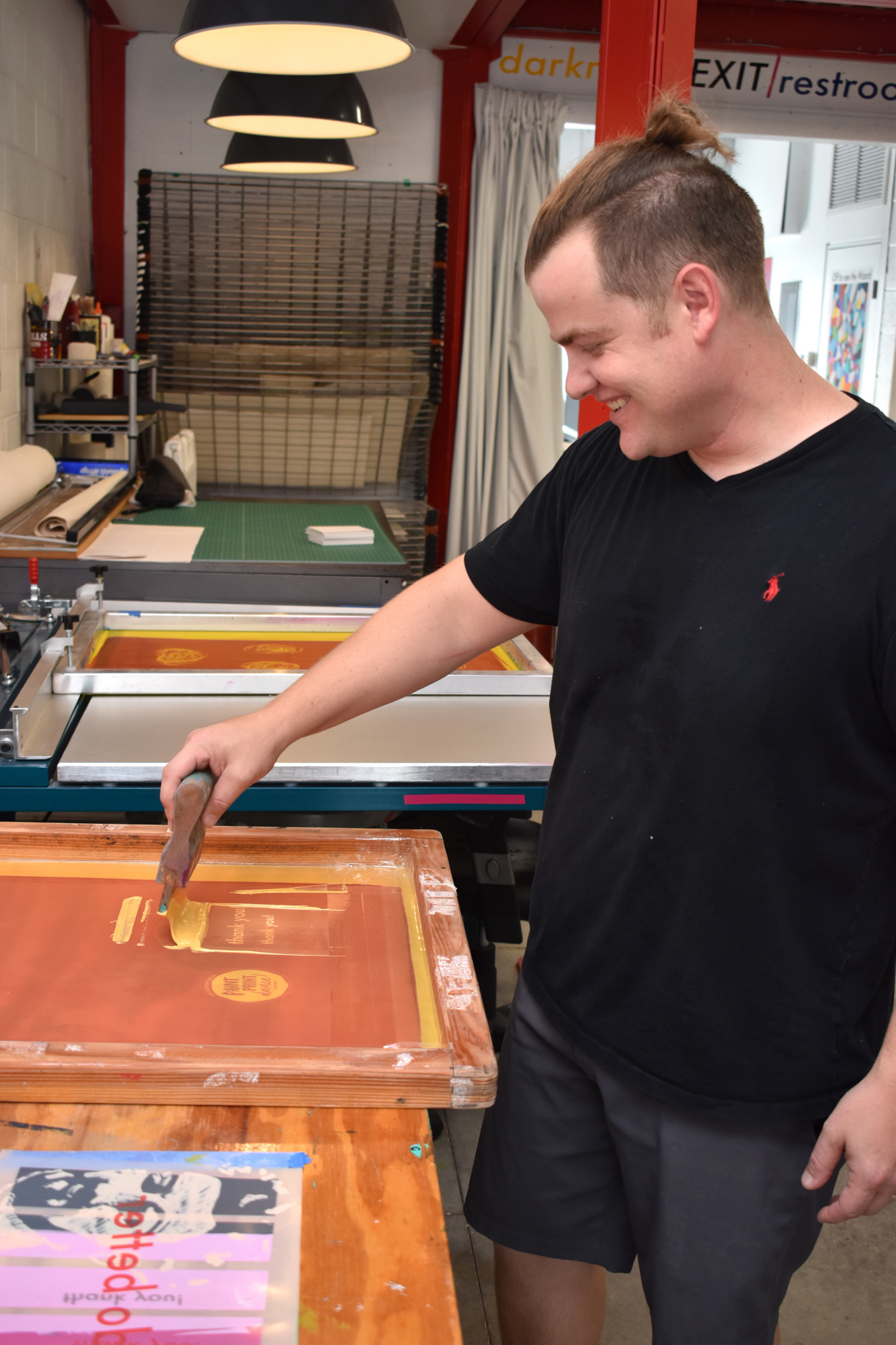 Chris Schumaker demonstrates how to make a print. Photo by Niki Kottmann