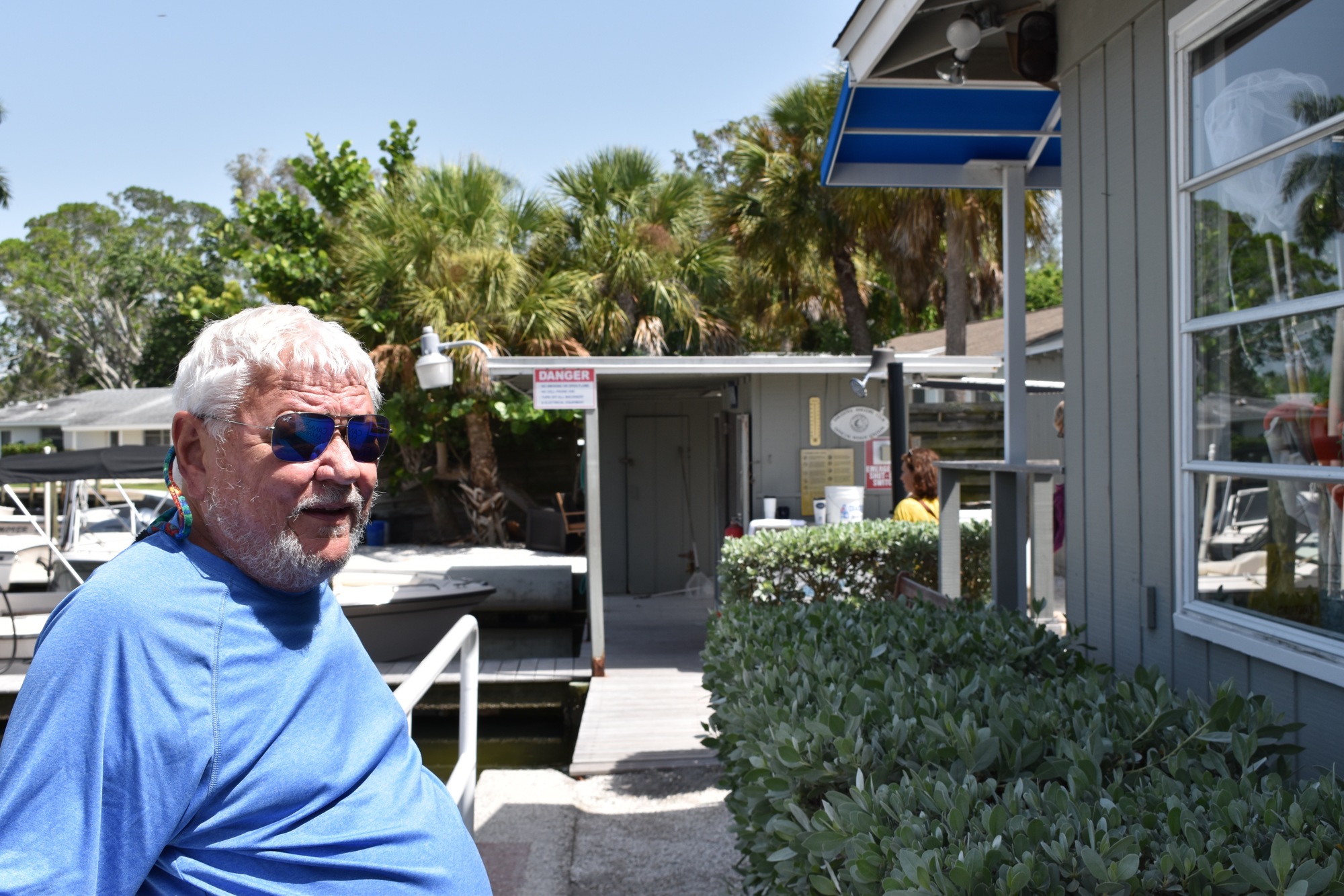 David Miller stands in front of the marina's main office building and adjacent to the marina's initial structure. 