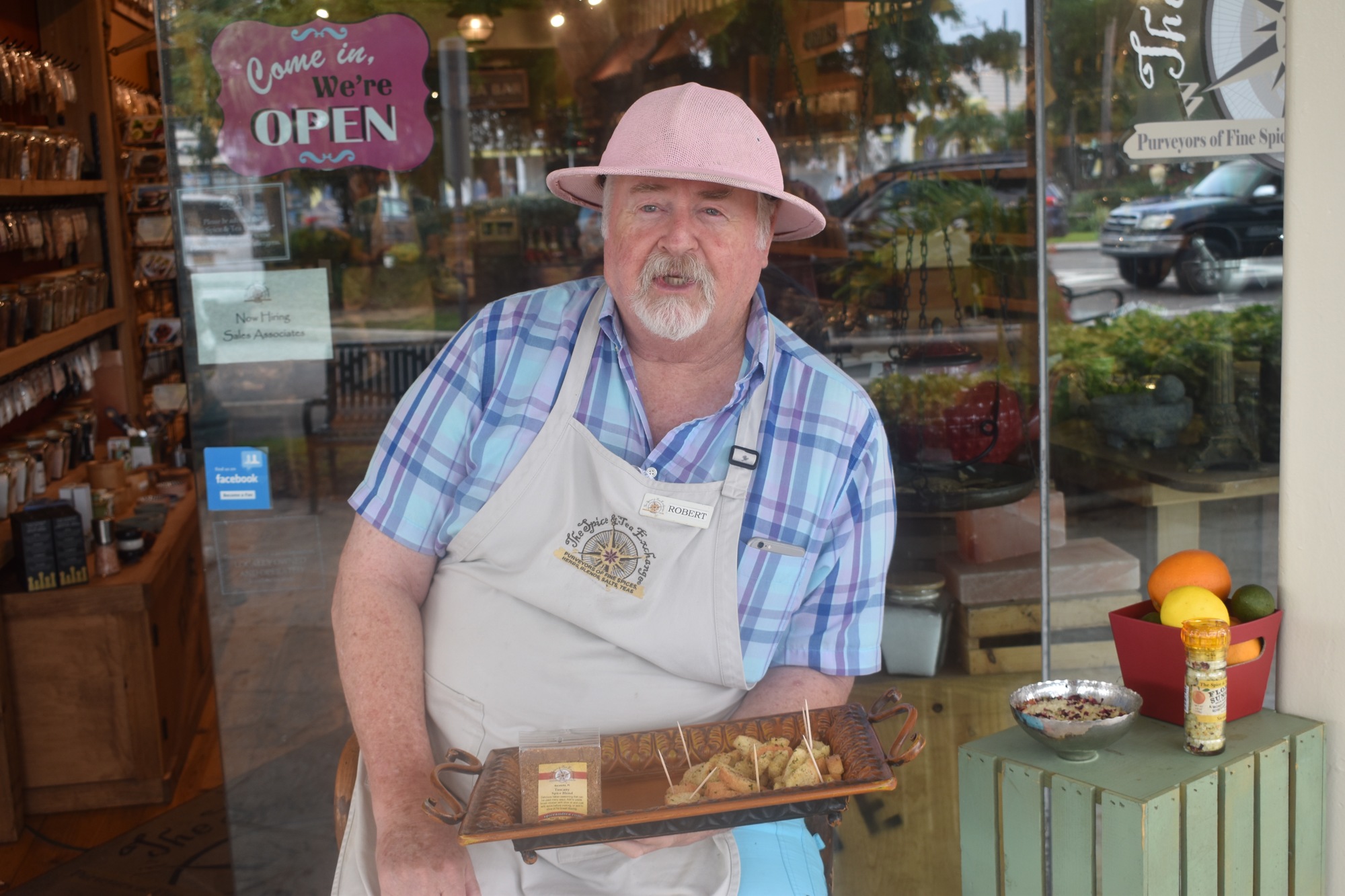 Robert Allan offers samples to passerby at Spice & Tea Exchange. 