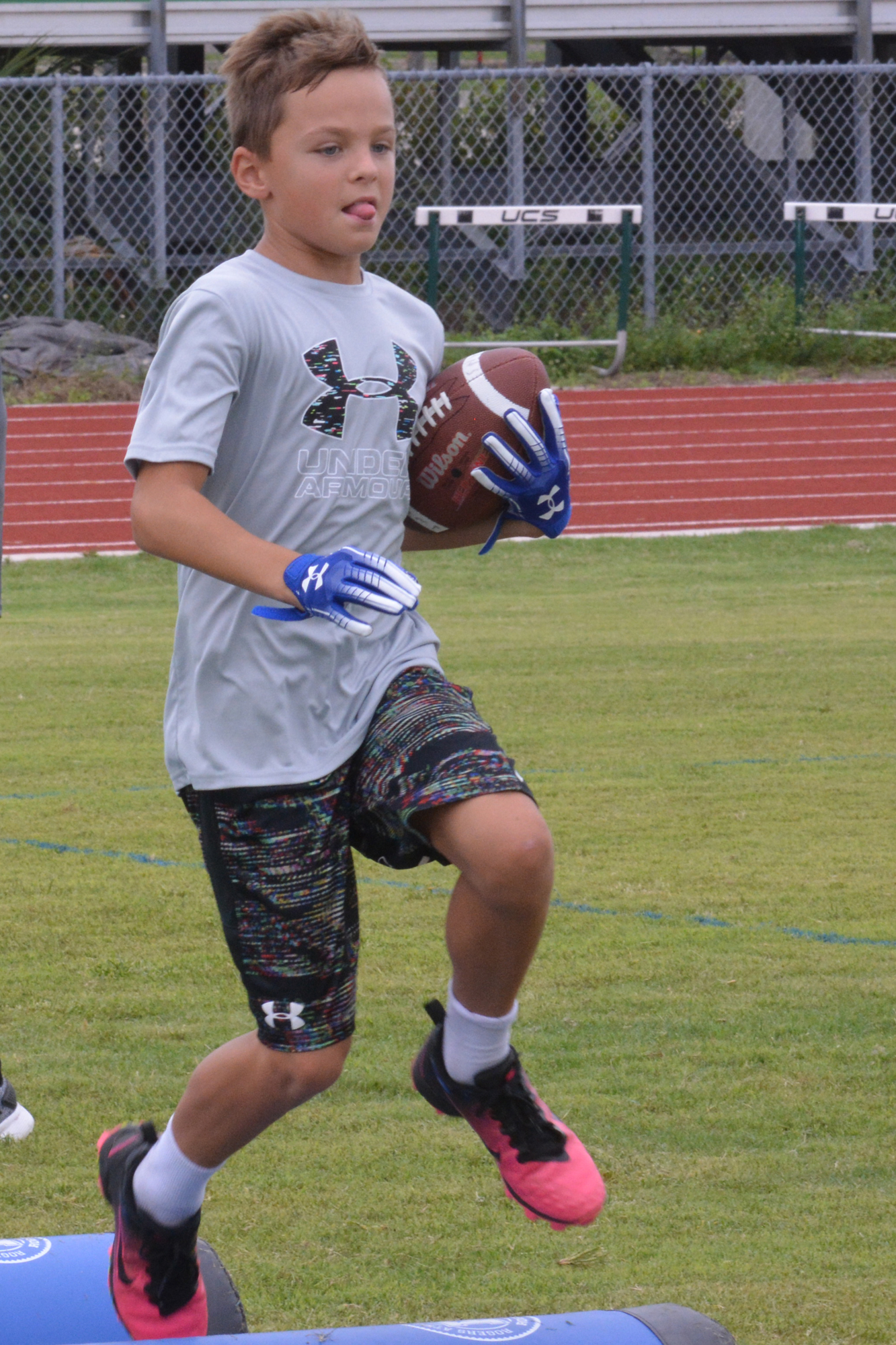 Evan Larrick goes through running back drills at the Fabian Moreau football camp.