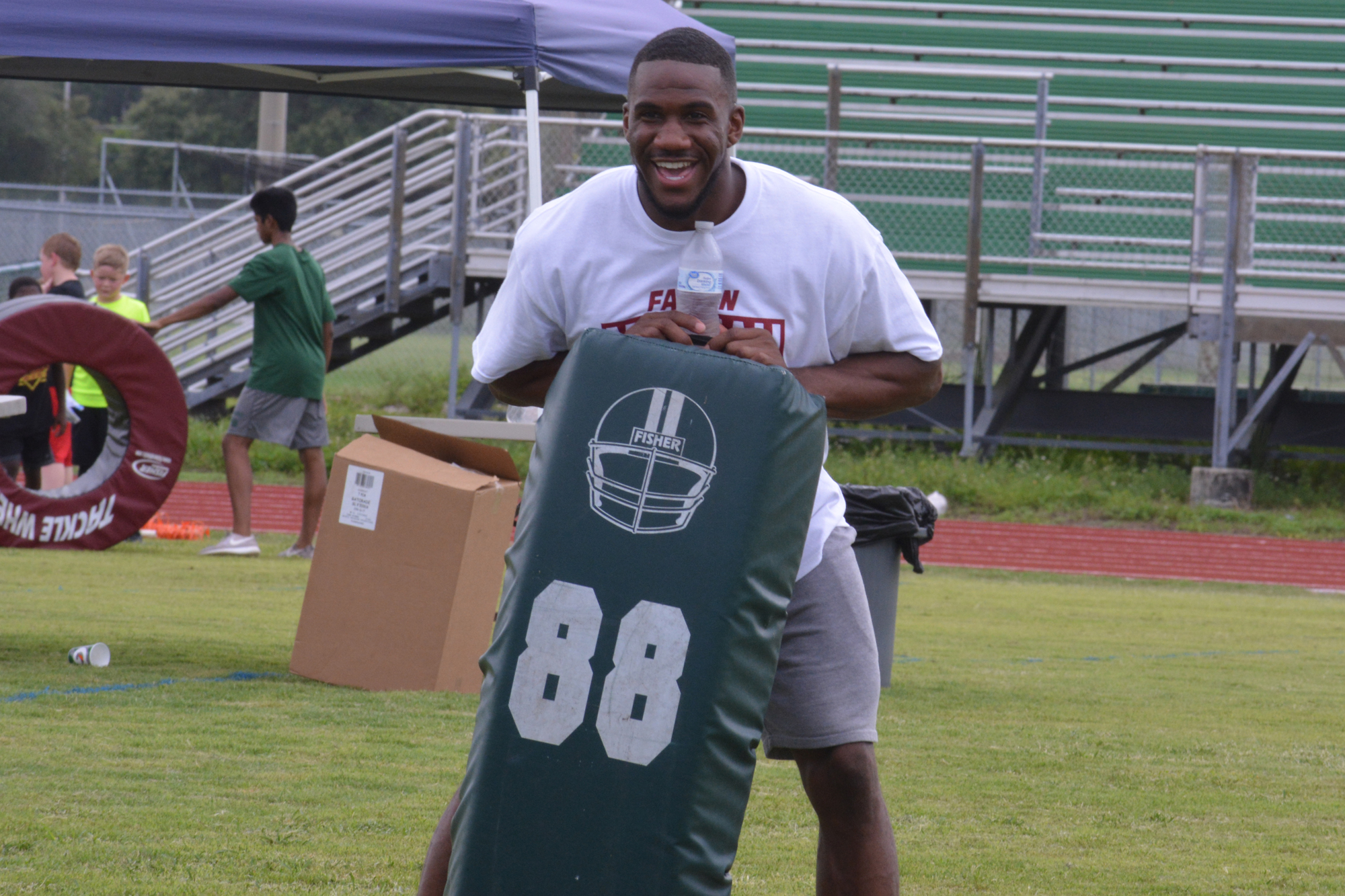 Fabian Moreau works the blocking bag at his summer football camp. Moreau was coached by current Lakewood Ranch High coach Rashad West at Western High.