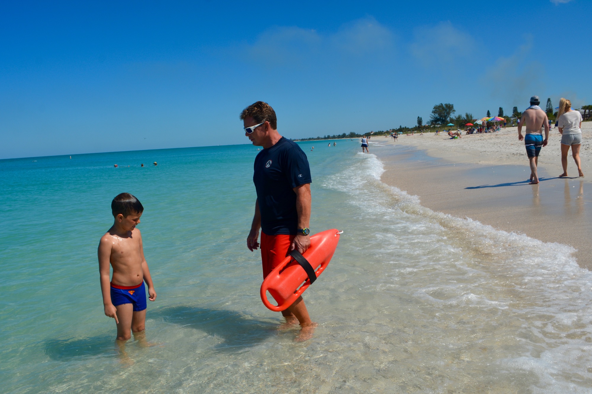 County lifeguard Mark Miller speaks to a young boy at Casey Key Beach