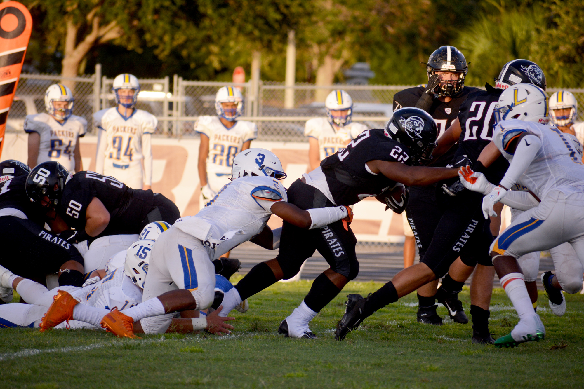 Pirates sophomore running back Lavontae Youmans (22) pushes through the Largo High defense.