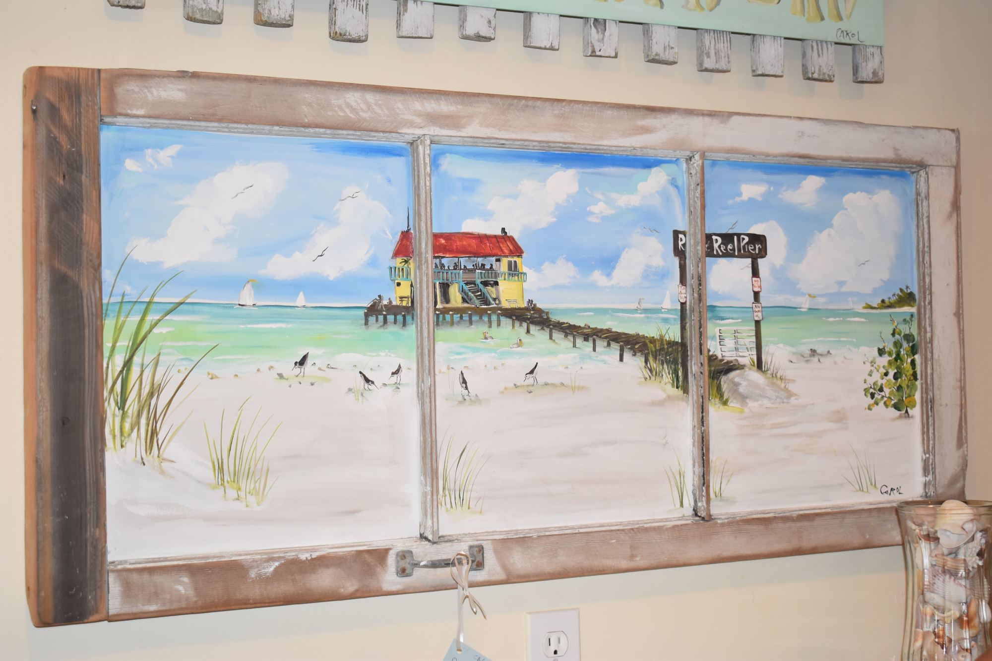 Is that the pier outside? Roman painted this scene on an old window frame.