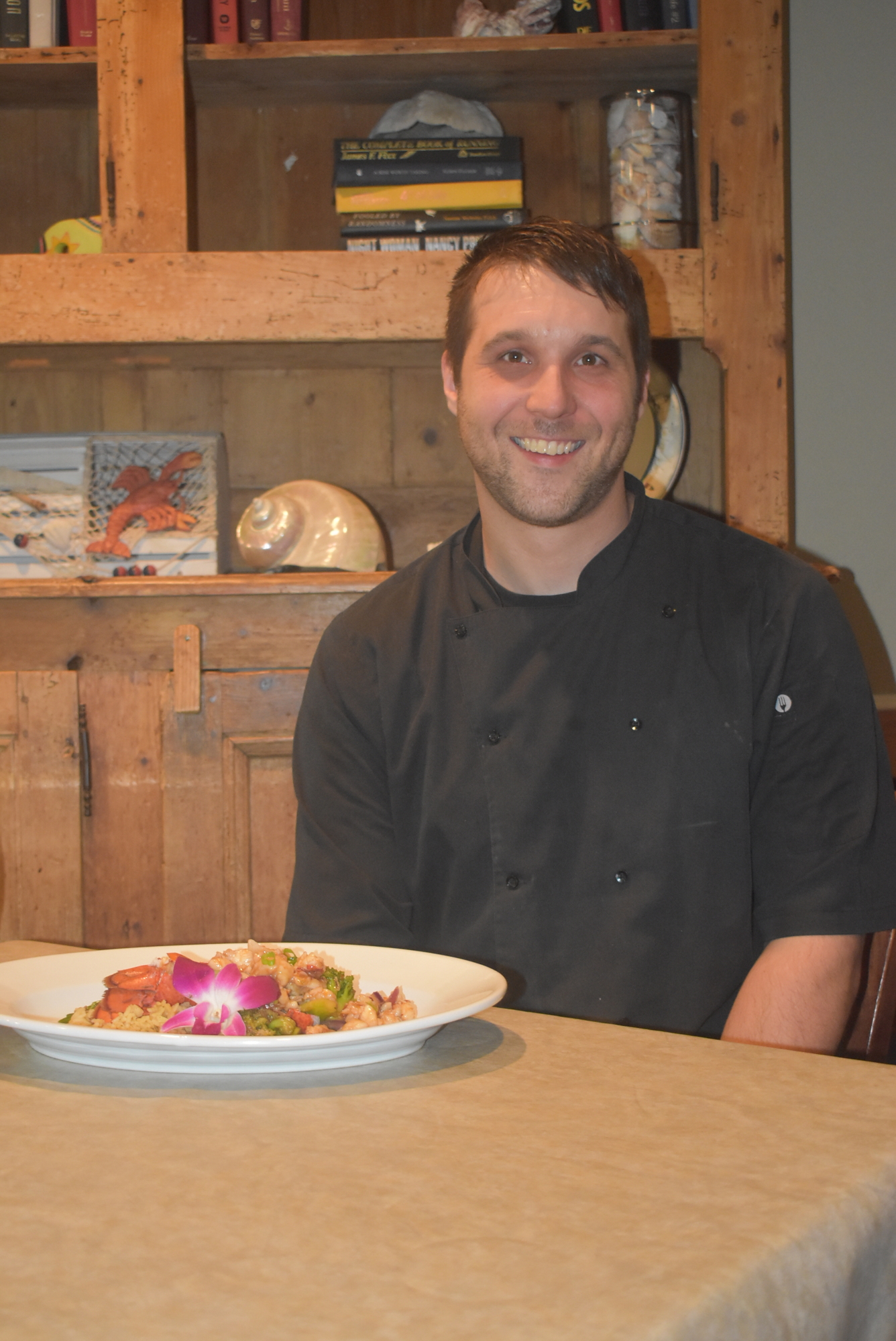 Chef Chris Reed sits with his creation.