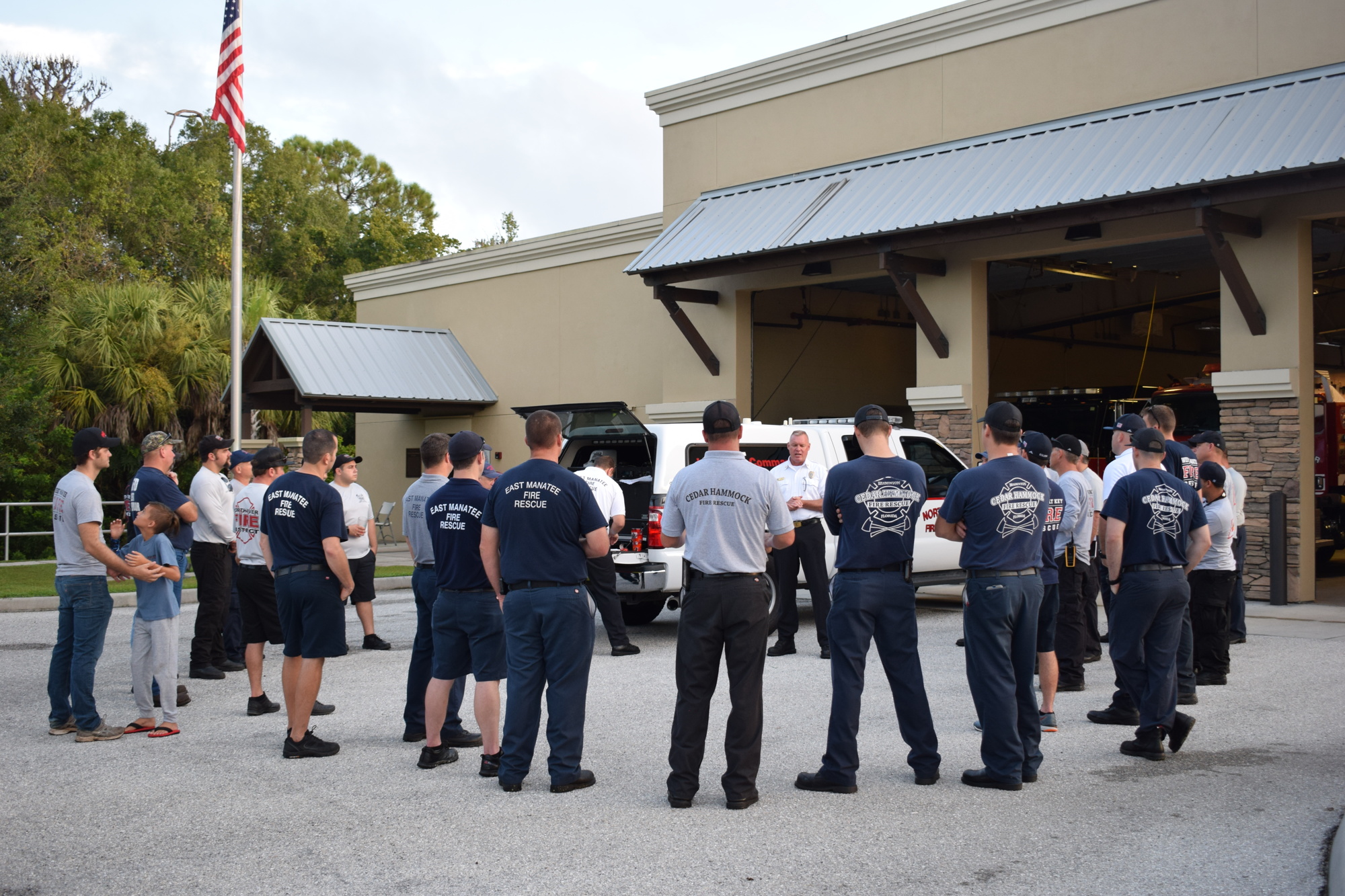 Firefighters gather for instructions before heading to Orlando.