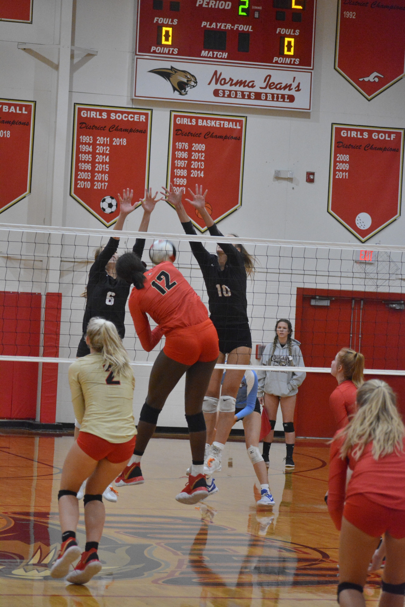 Cardinal Mooney freshman Jordyn Byrd (12) smashes a kill past two Riverview blockers. She finished with 14 kills.