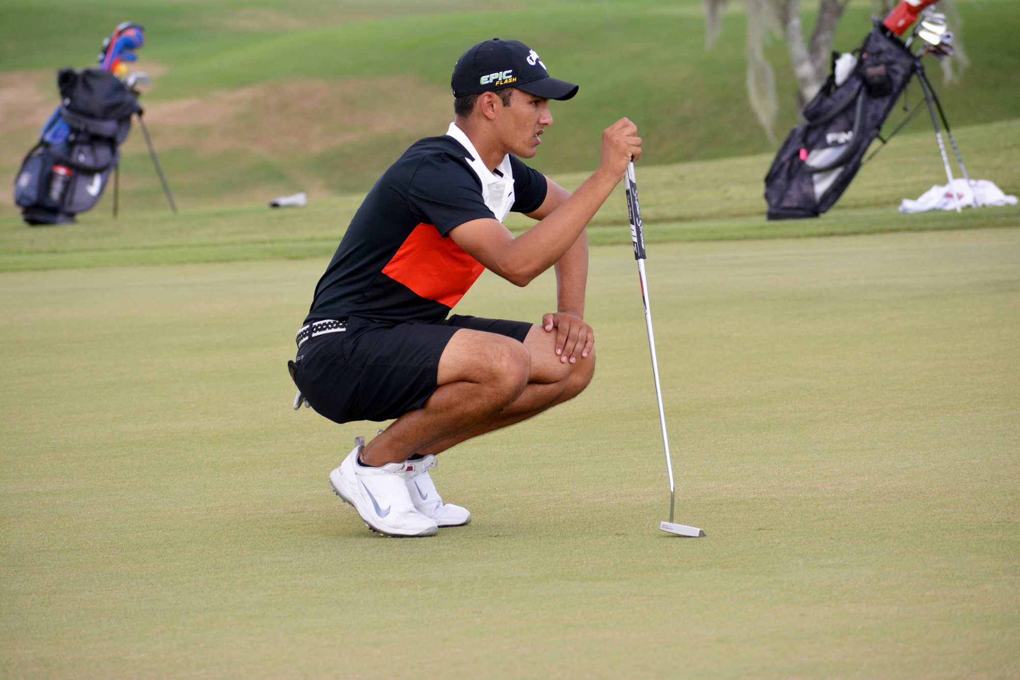 Cardinal Mooney senior boys golfer Noah Kumar, here reading the green, is ranked No. 1 in Florida by the FHSAA.