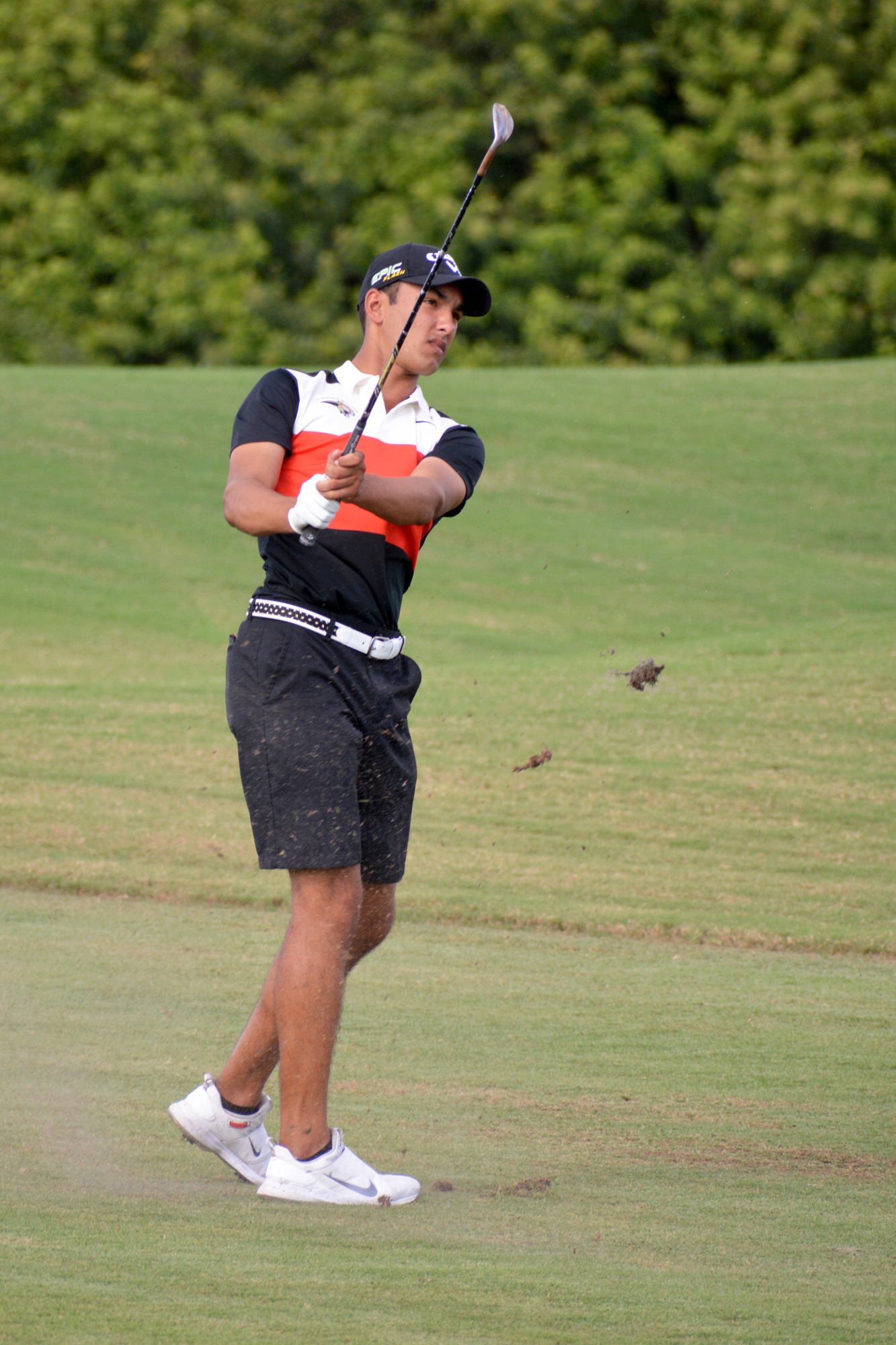 Cardinal Mooney senior boys golfer Noah Kumar takes a shot from the fairway.