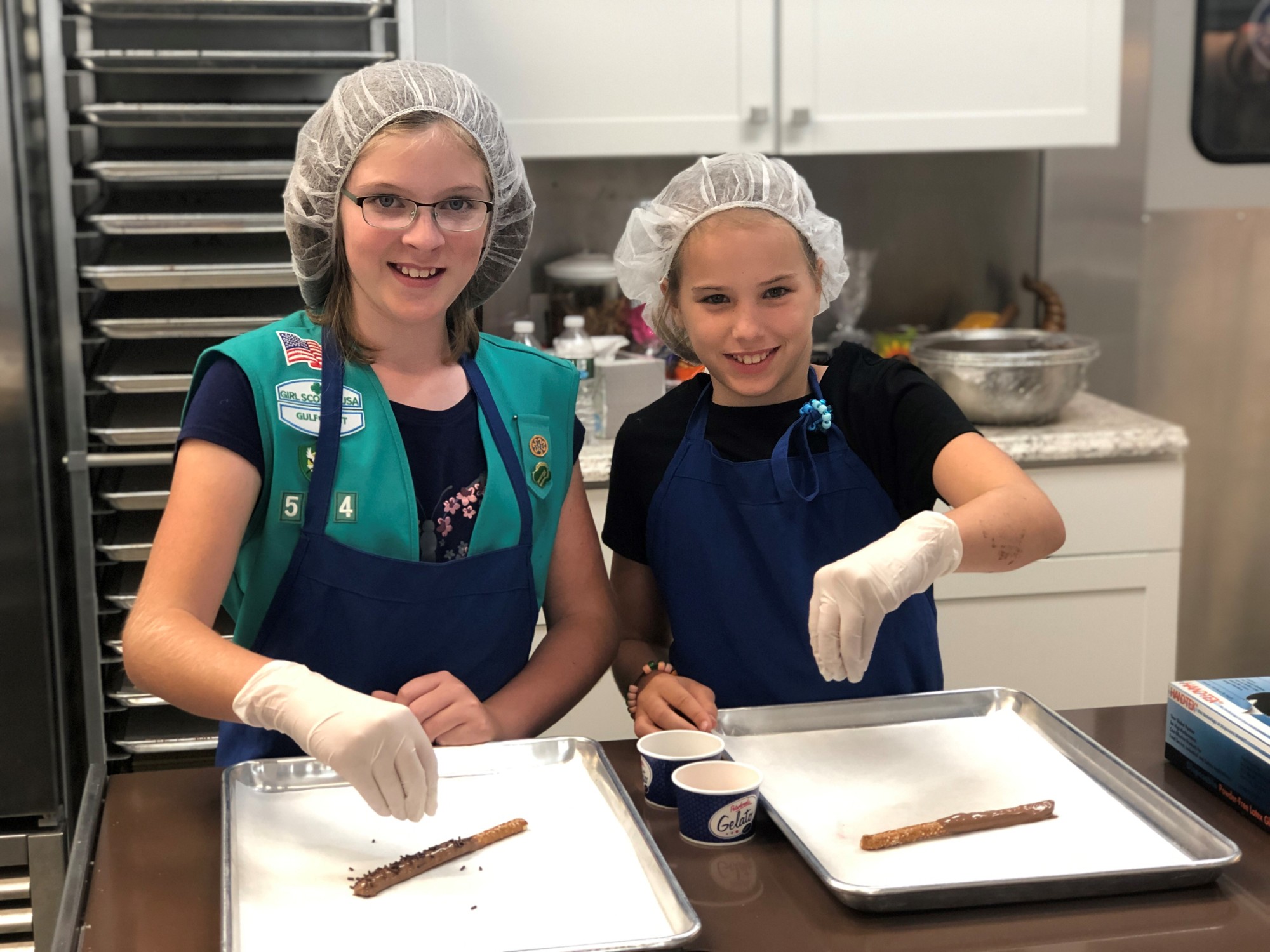Allison Rothhaar and Alyssa Otterness put sprinkles on their chocolate pretzels. Courtesy photo.