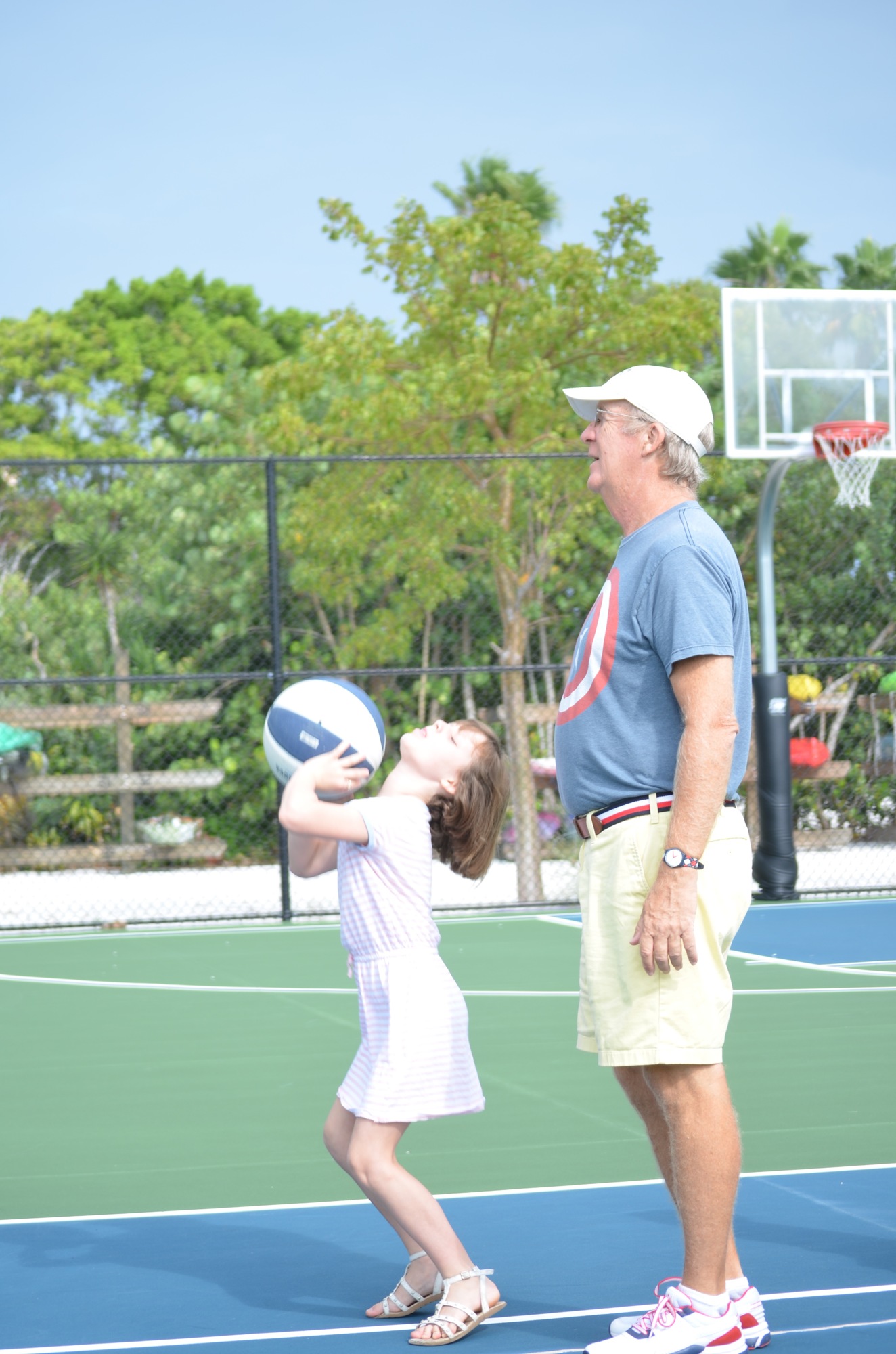 Maya Welch and her grandfather, Nick Florio shoot some baskets.