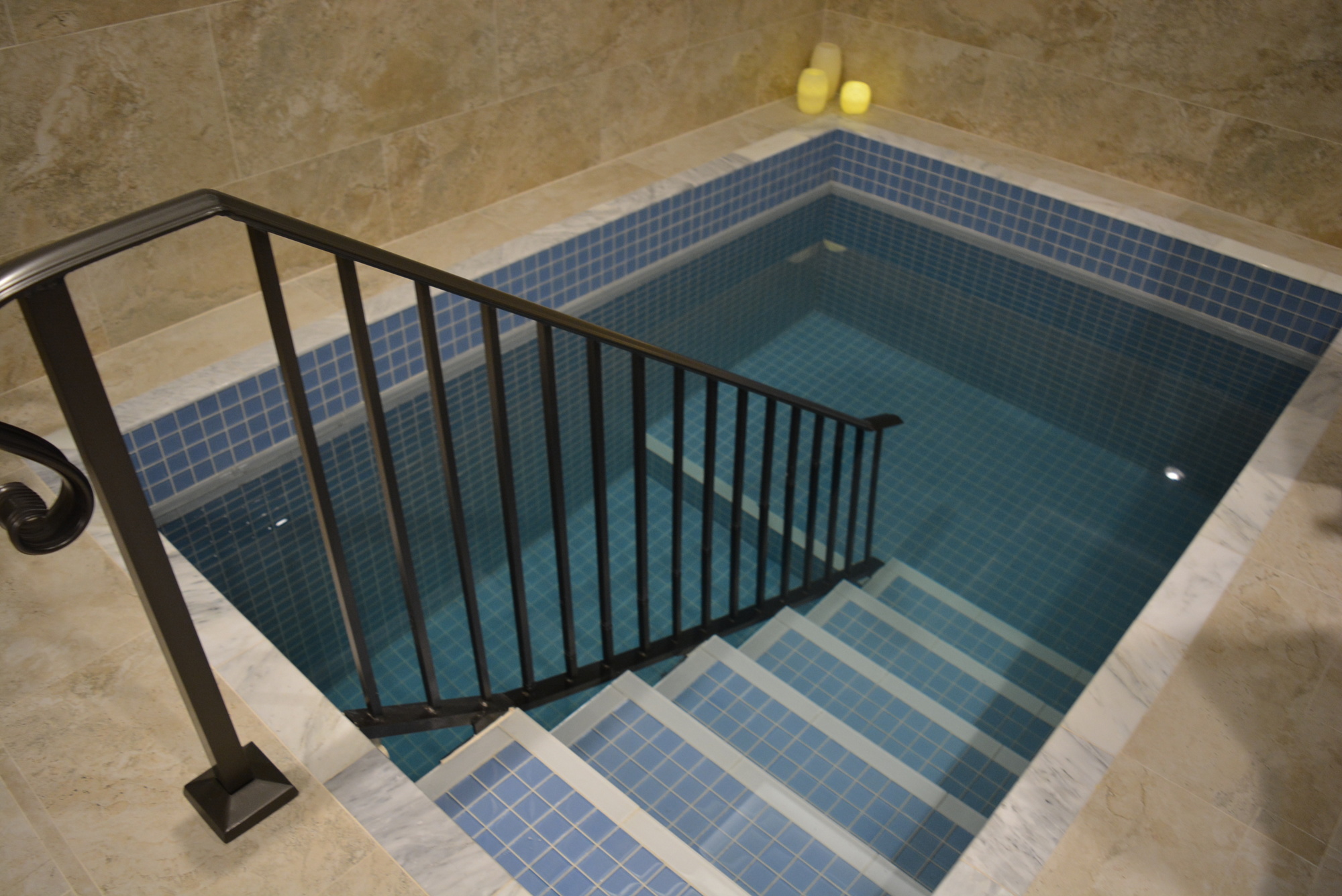 The mikvah is a ceremonial bath for  women. In accordance with Judaism, the mikvah must hold at least 200 gallons of natural water so this one is designed with rainwater in a separate pool below the chlorinated one used by guests.
