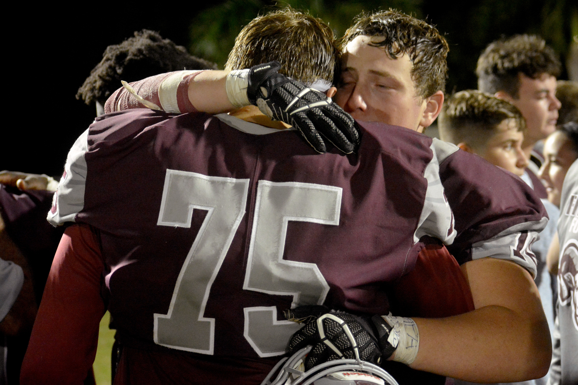 Nathan Langlais (75) and Alec Kable console each other after the loss.