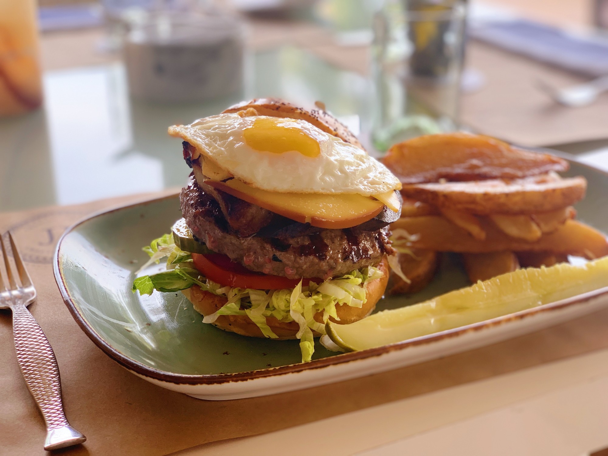 A burger with a fried on top served at The Ritz-Carlton's Jack Dusty is the picture of brunch.
