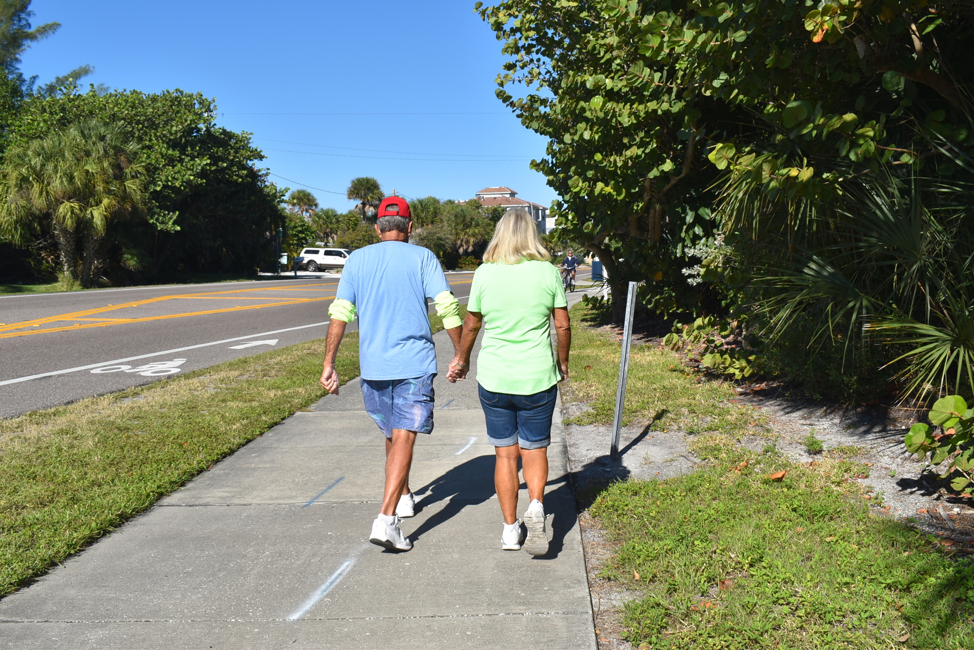 Kirt and Mary Ann Bopp hold hands as they walk.