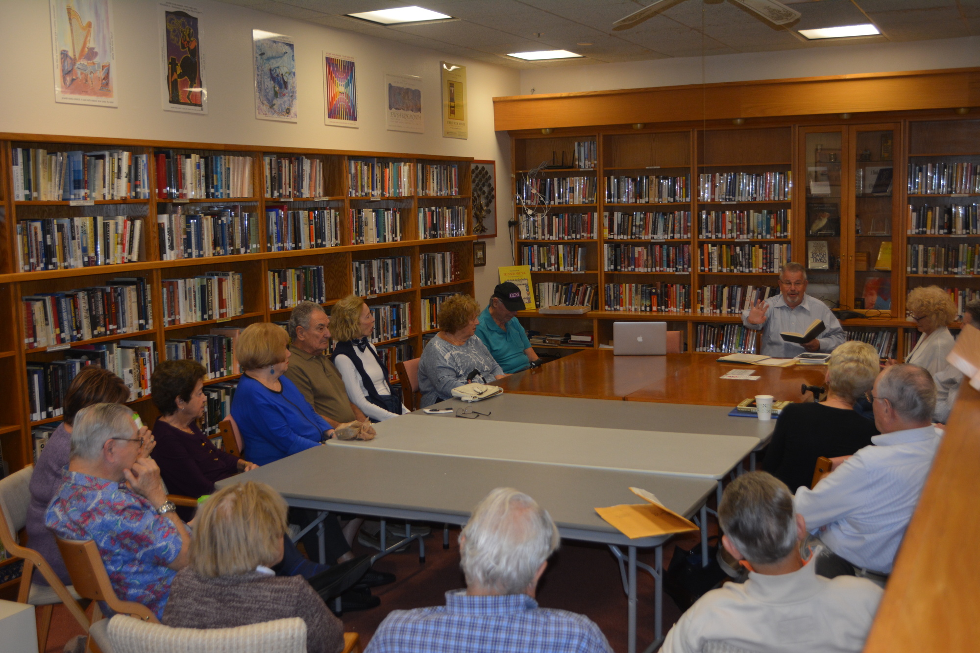 Rabbi Stephen Sniderman speaks to congregants during a lesson about Kristallnacht. Nineteen people attended the session.