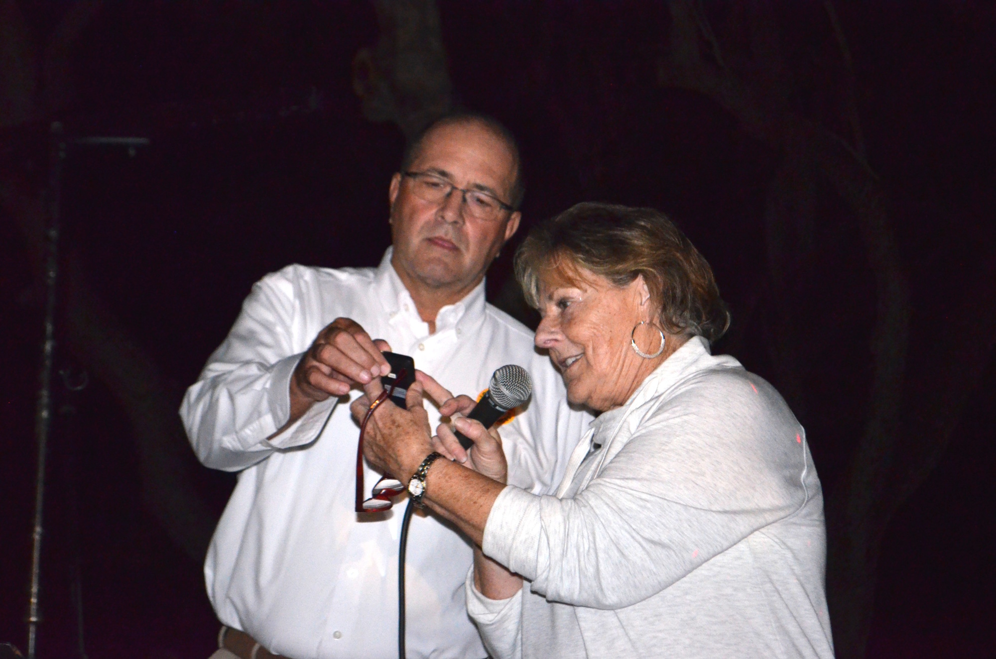 Town Manager Tom Harmer and Longboat Key Chamber of Commerce President Gail Loefgren push the button on to light the trees.