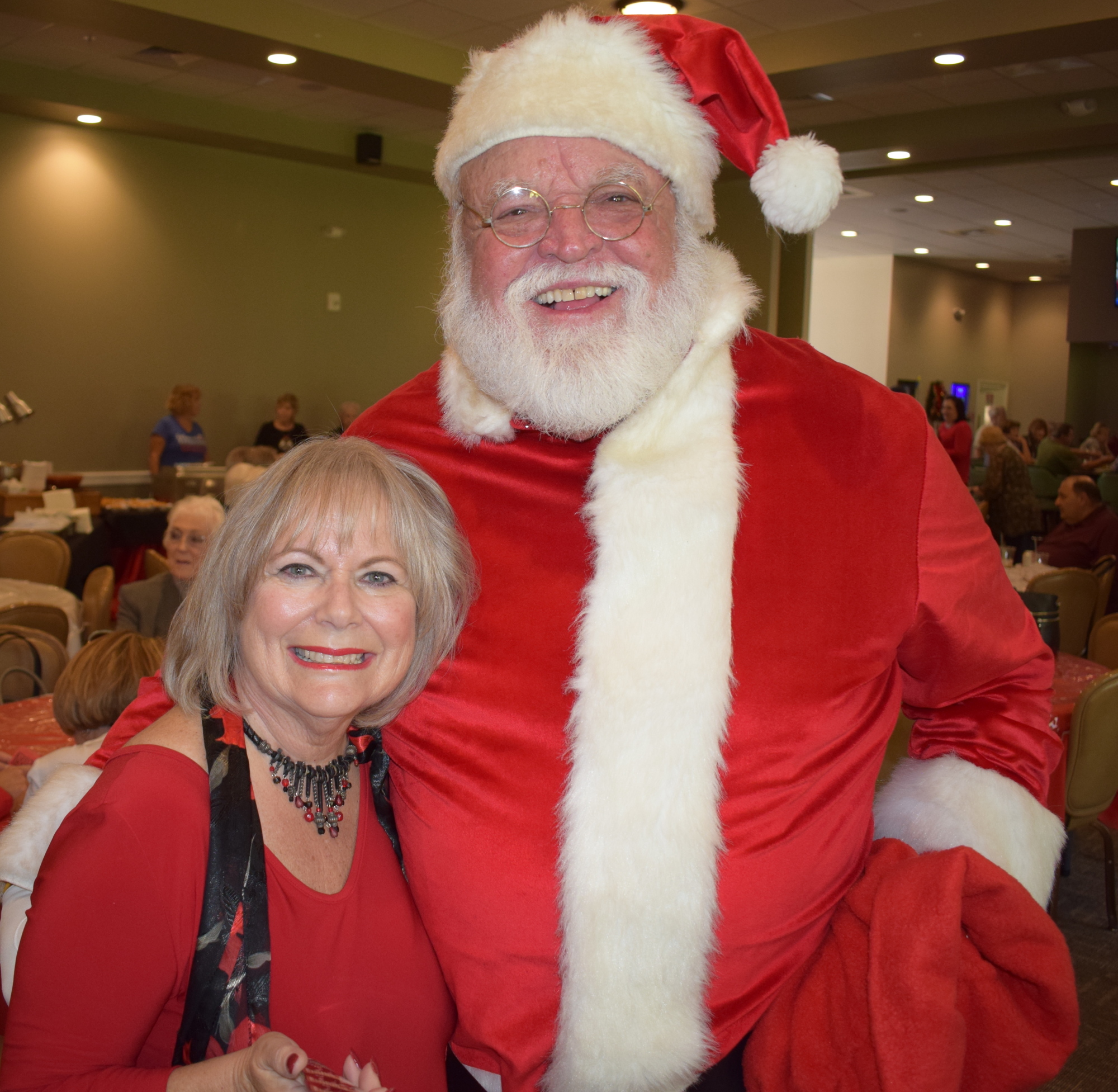 Meals on Wheels PLUS volunteer Sharon Zawadski gets a hug from Santa (Elks member Ron Lee) at the event.