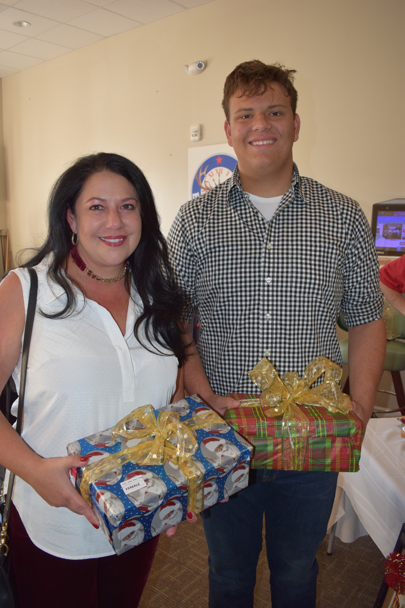 River Pointe's Leah Zammit and her son, Luke Sudul bring gifts to the Shoebox Drive.
