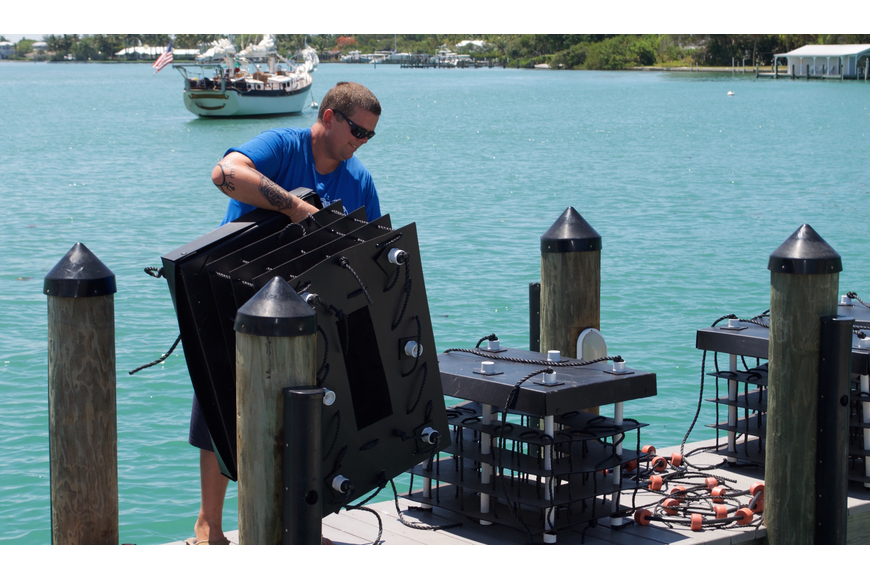 David Wolff prepares to submerge 10 mini-reefs at MarVista on Longboat Key.