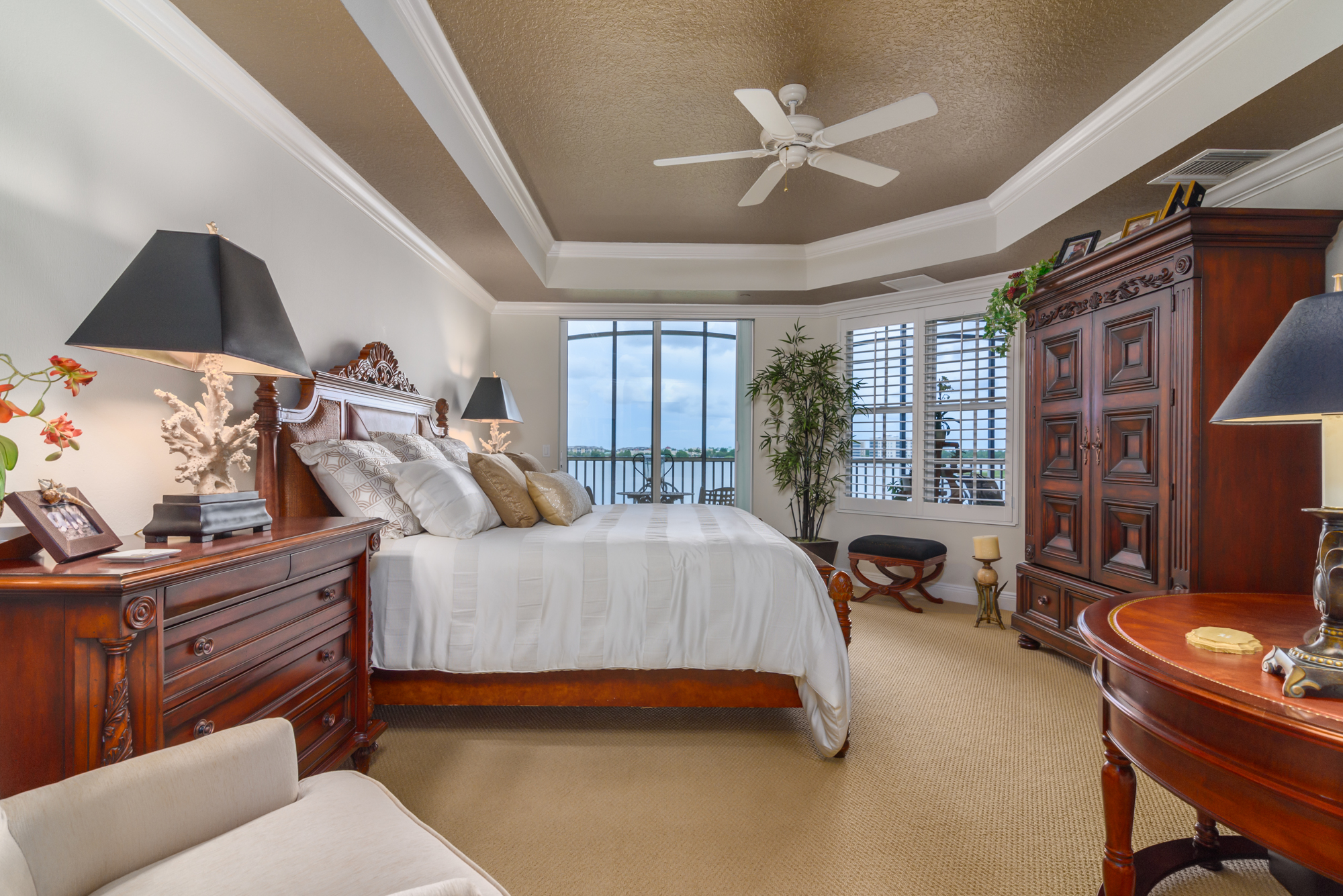 An elegant trayed ceiling adds drama to the master bedroom. Sliders open to the screened balcony overlooking the water view. A master bath with a soaking tub and separate walk-in shower top off the master suite.