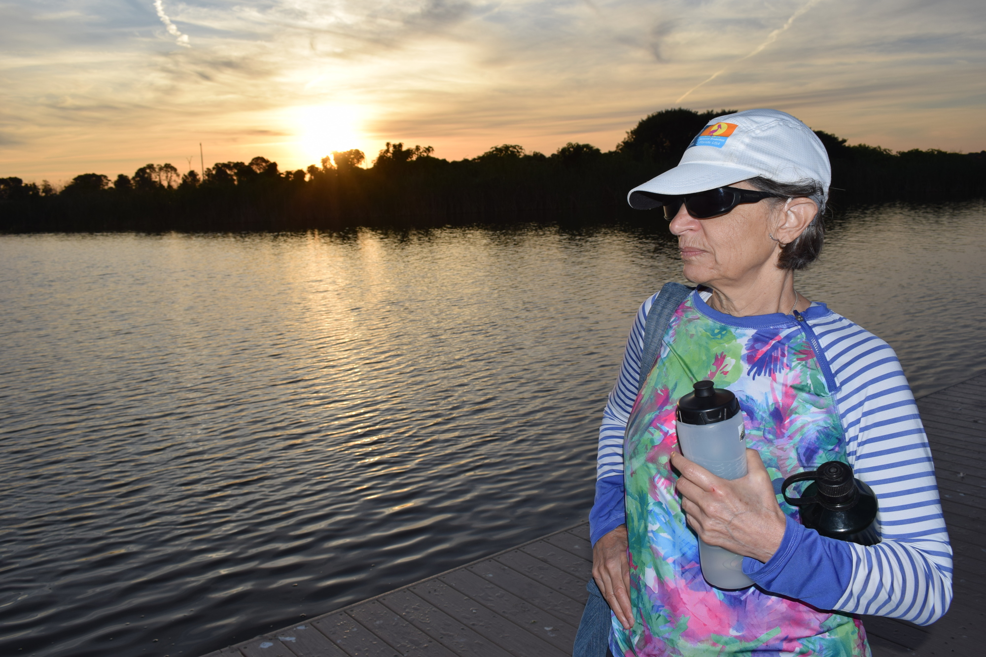 Linda Mumford awaits her practice row as the sun rises at Nathan Benderson Park.