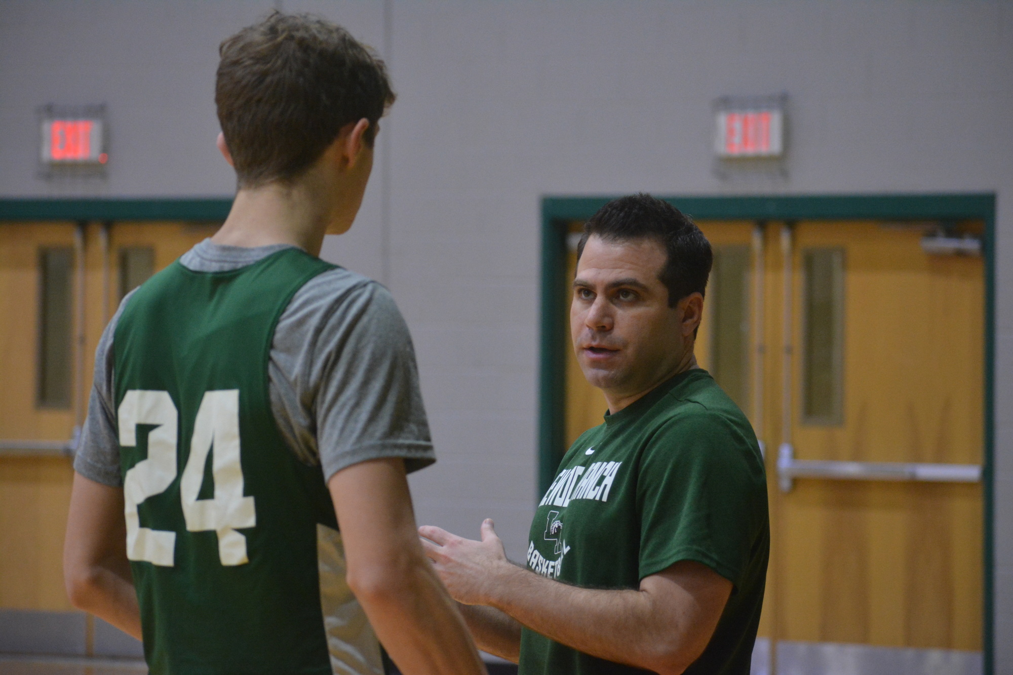 Lakewood Ranch boys basketball forward Andres Junge talks with coach Jeremy Schiller at practice.