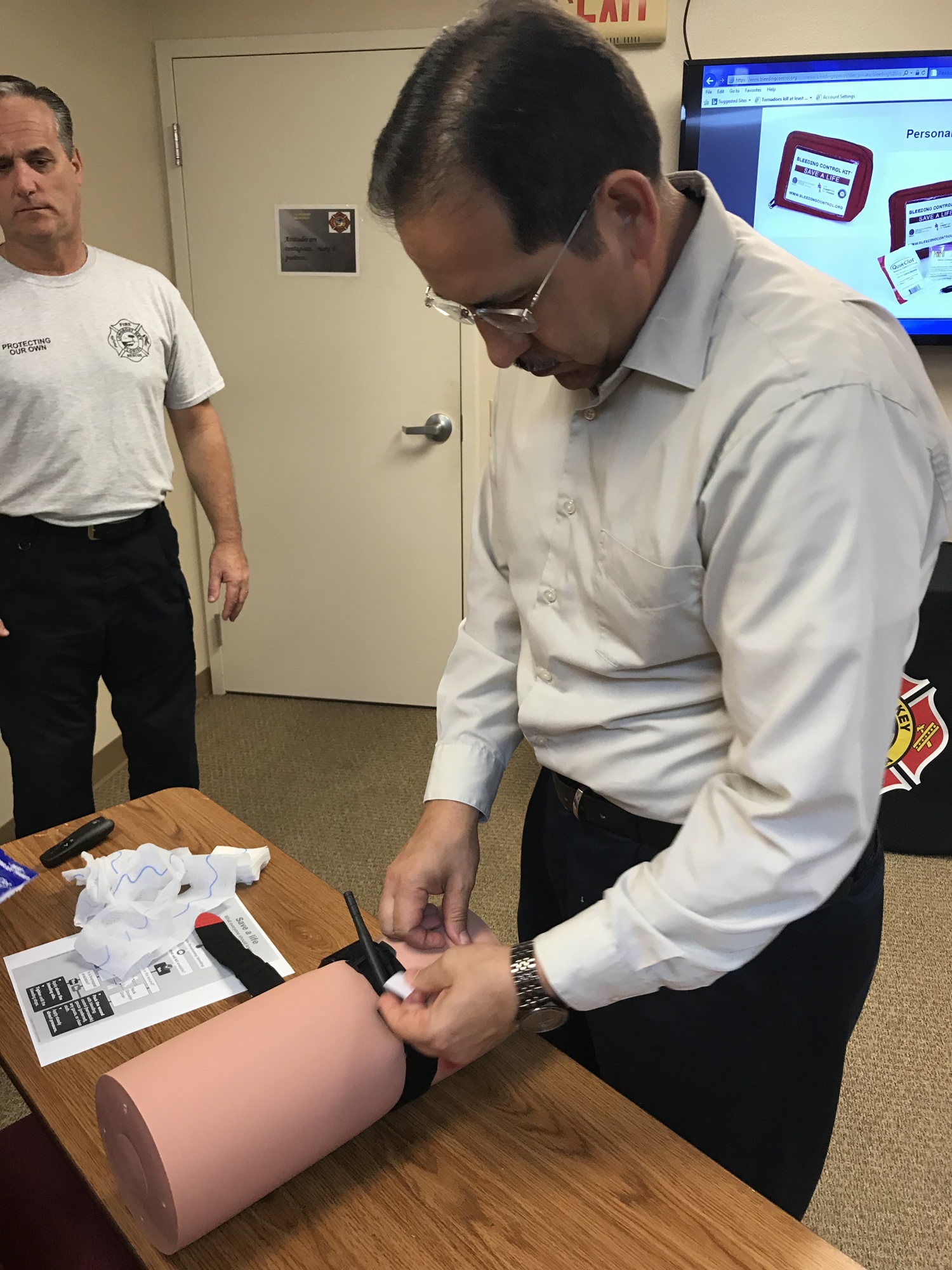 An attendee learns a technique to control bleeding as Longboat Key Fire Chief Paul Dezzi observes at a Stop the Bleed training session. (Photo courtesy of Longboat Key Fire Rescue Department)