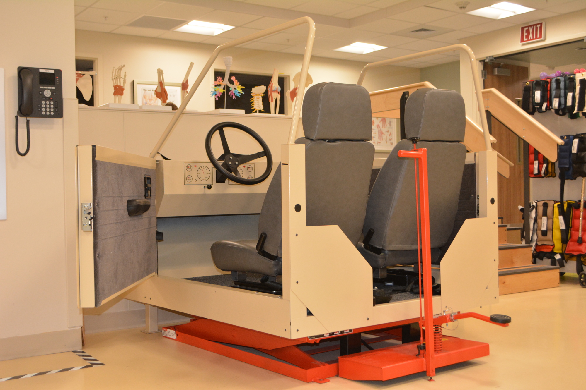 Patients use this structure to practice getting in and out of the car. The device's height can be adjusted to practice for vehicles of many sizes.