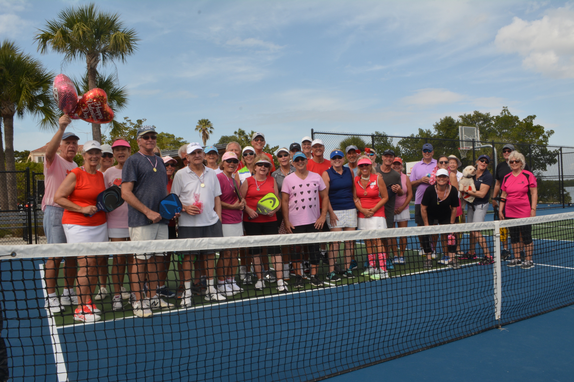People who stayed until the end of the Beauty and the Beast tournament pose on one of the pickleball courts Friday.