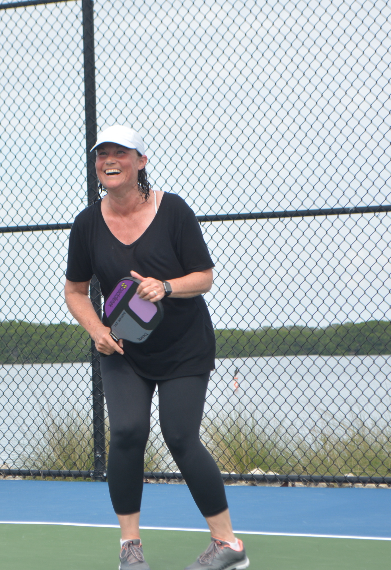 Debra Sauers laughs after a point during her pickleball game Friday at the Beauty and the Beast tournament.