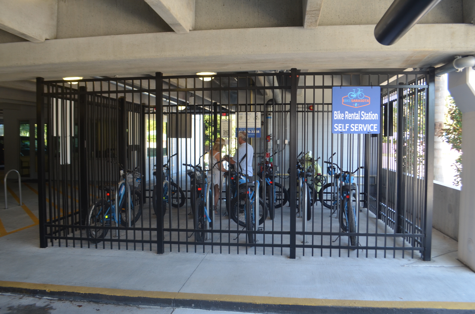 Lido Key residents Sheila and Greg Masterson rent a bike at the St. Armands parking garage, which the city established as a pilot program last month.