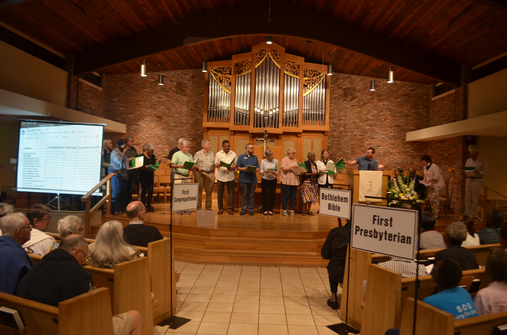Representatives for SURE constituent congregations share their attendance figures during a rally Monday.