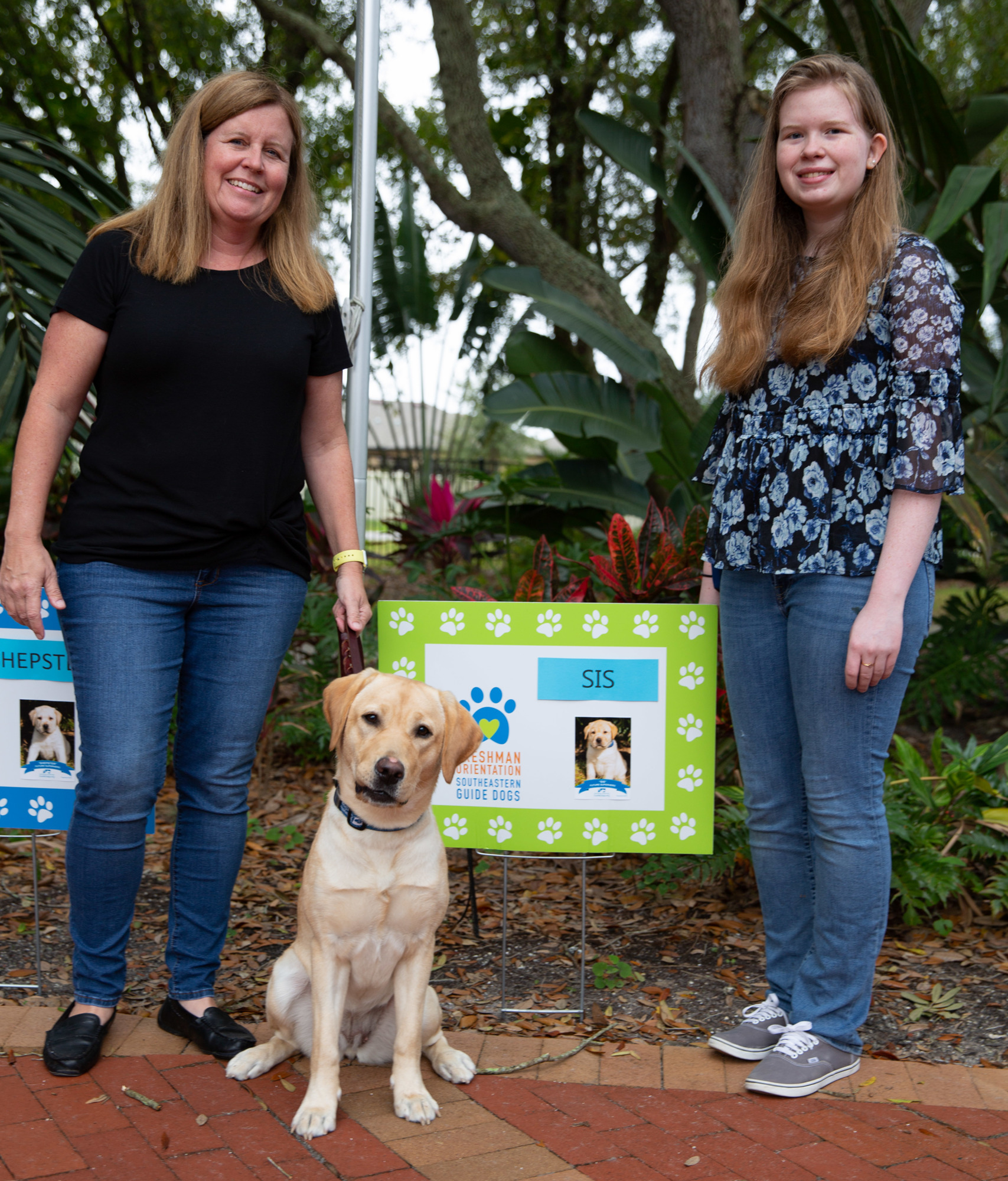 Kim Anderman and her daughter, Camryn Brielmann, with PIT SIS at her freshman orientation. At more than a year old, SIS is ready to move on to formal guide dog training on the SEGD Campus.
