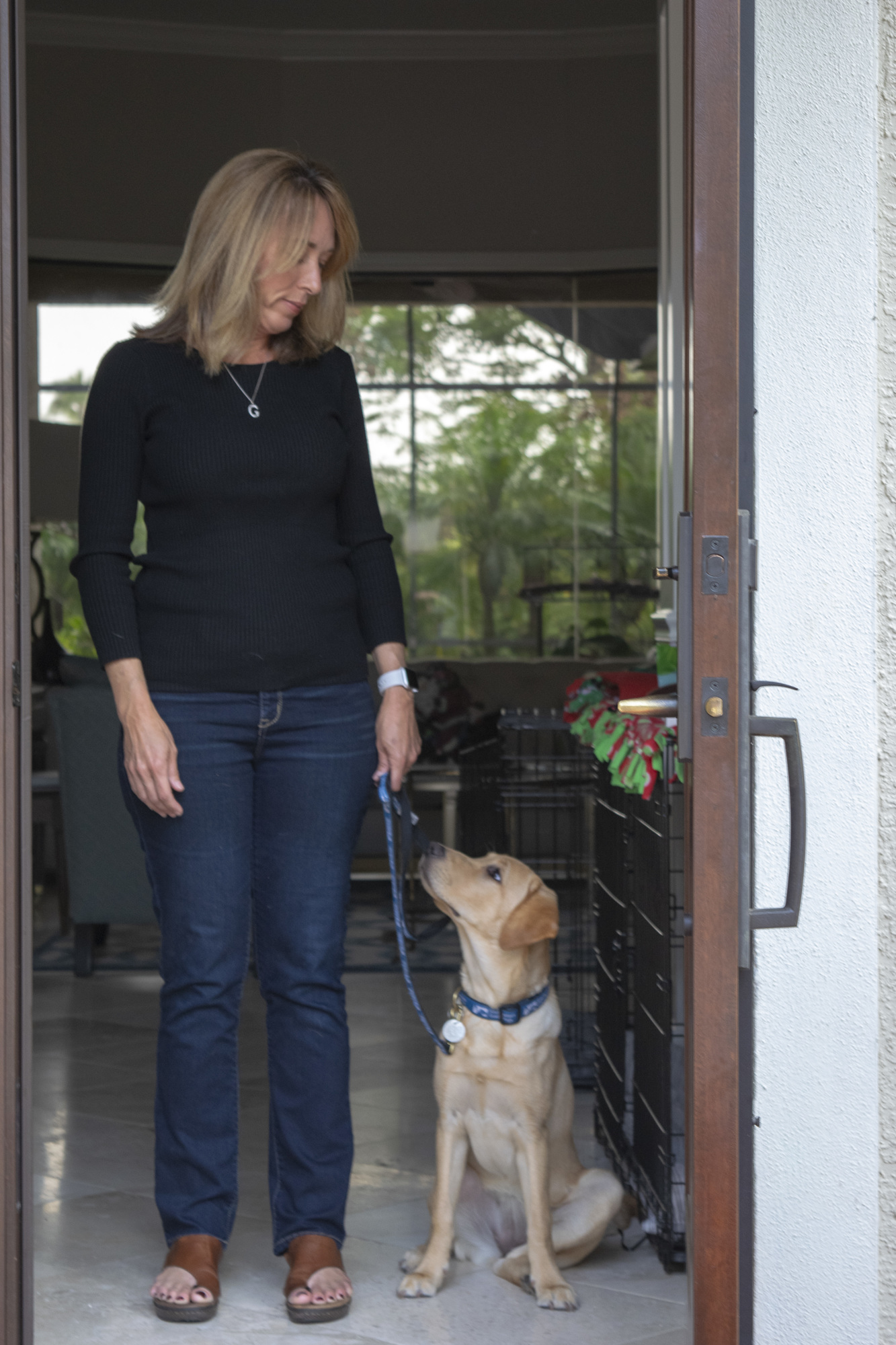 Gina Hagopian and guide dog pup in training Liberty. Raisers teach pups basic commands, such as how to sit before walking through any door.