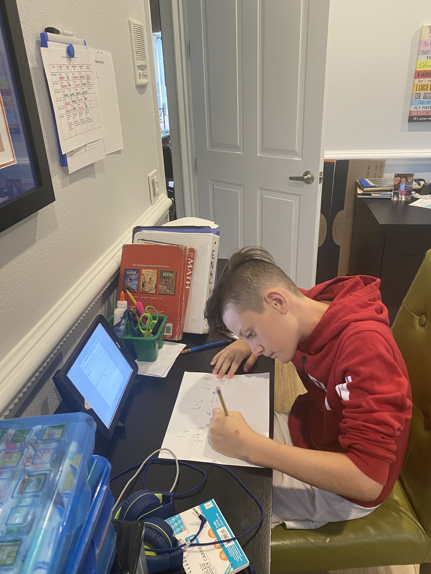 Colt Chalmers, a sixth grader at Out-of-Door Academy, works on math problems. The Chalmers are in need of a fourth device so Colt Chalmers and his brother, Camden, can do assignments online at the same time. Courtesy photo.