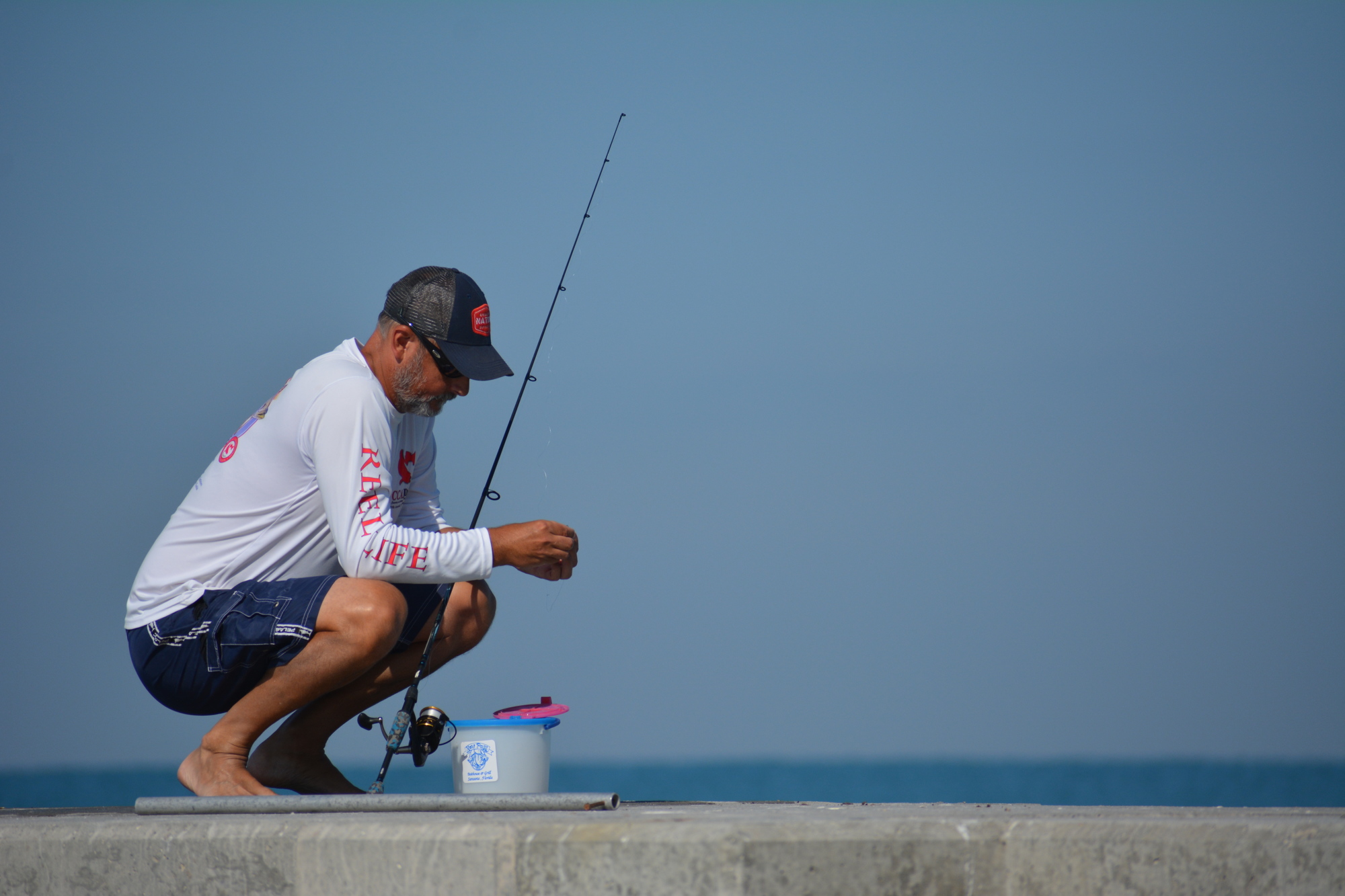 Steve Nicolai, a former client and current friend of Beach Fishing Adventures proprietor Steven Herich, prepares his line for casting Saturday on Longboat Key.