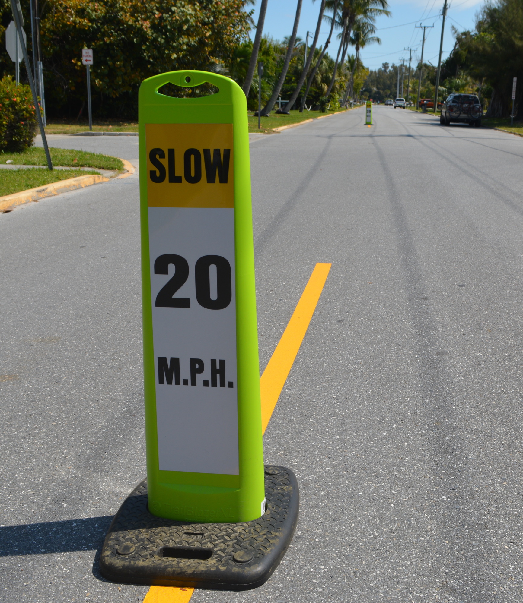 Paddles in the center of Broadway Street warn drivers of a 20 mph speed limit.