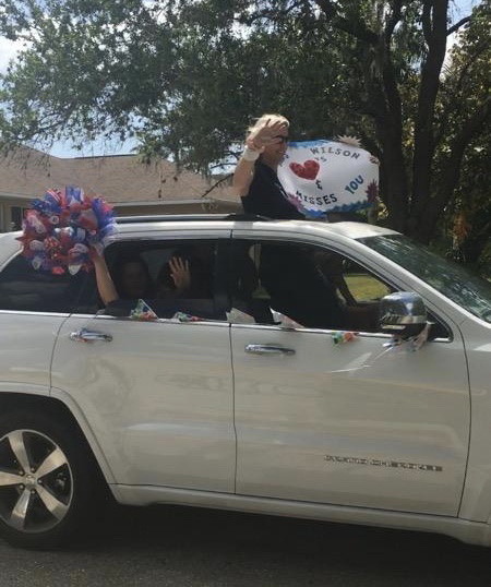 Freedom Elementary School third grade teacher Gina Wilson cheers for her students during an e-learning kickoff parade.
