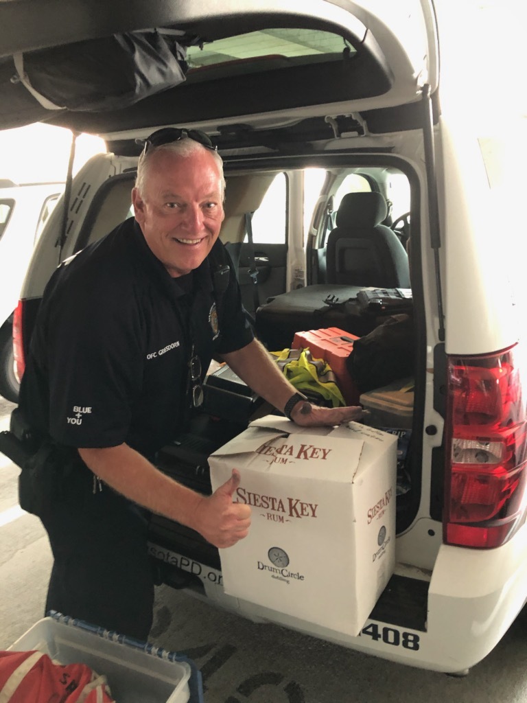 Sarasota Police Officer Dan Griesdorn unloads hand sanitizer donated by Siesta Key Rum. Photo courtesy