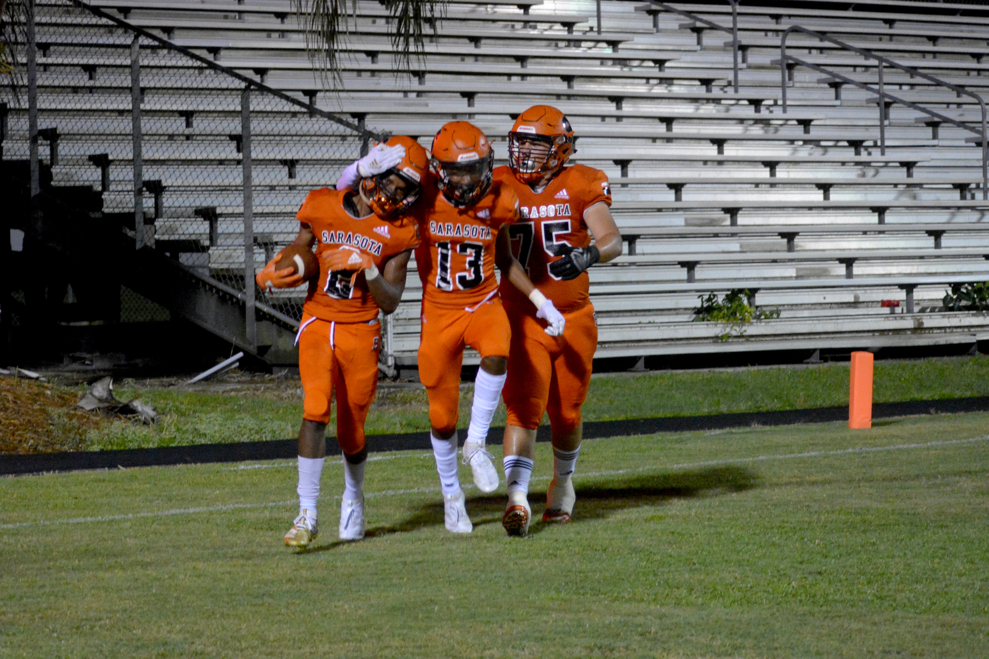 Sarasota High seniors Thomas Pack, McKeyvion Cain and Jacob Carnes celebrate after a Pack touchdown run on Sept. 13. Pack said of all the big senior events, he would be most disappointed by graduation getting canceled.