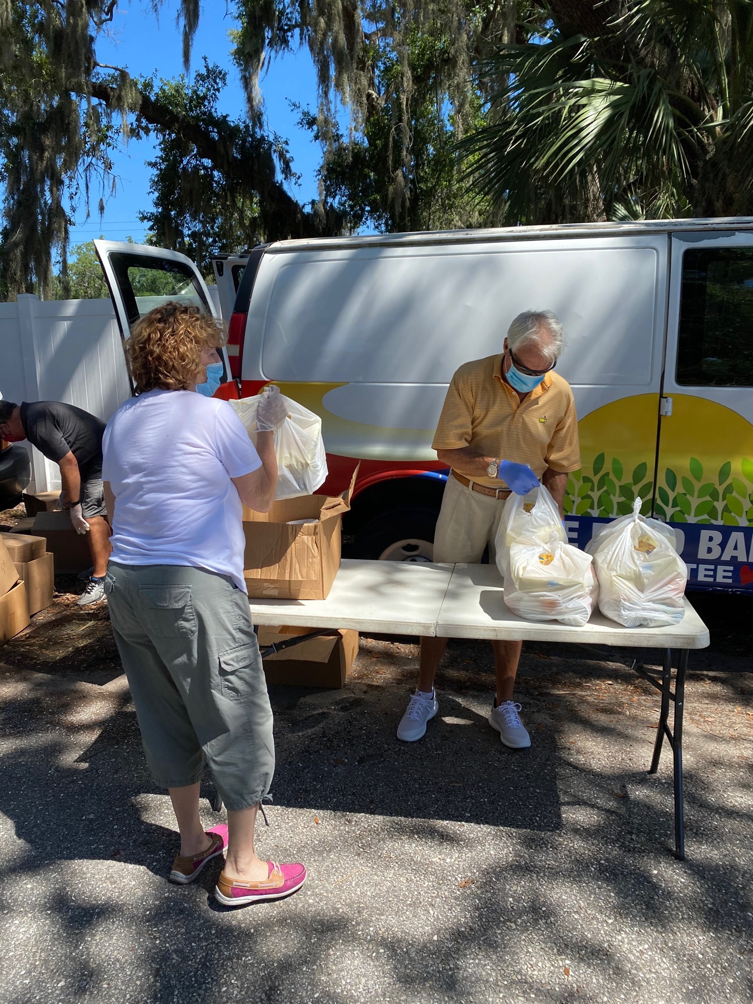 Charlene Moran and Mark Goodness package food for Meals on Wheels Plus of Manatee to distribute. The nonprofit raised $294,445 during the Giving Challenge, which will help provide more food for distribution. Courtesy photo.