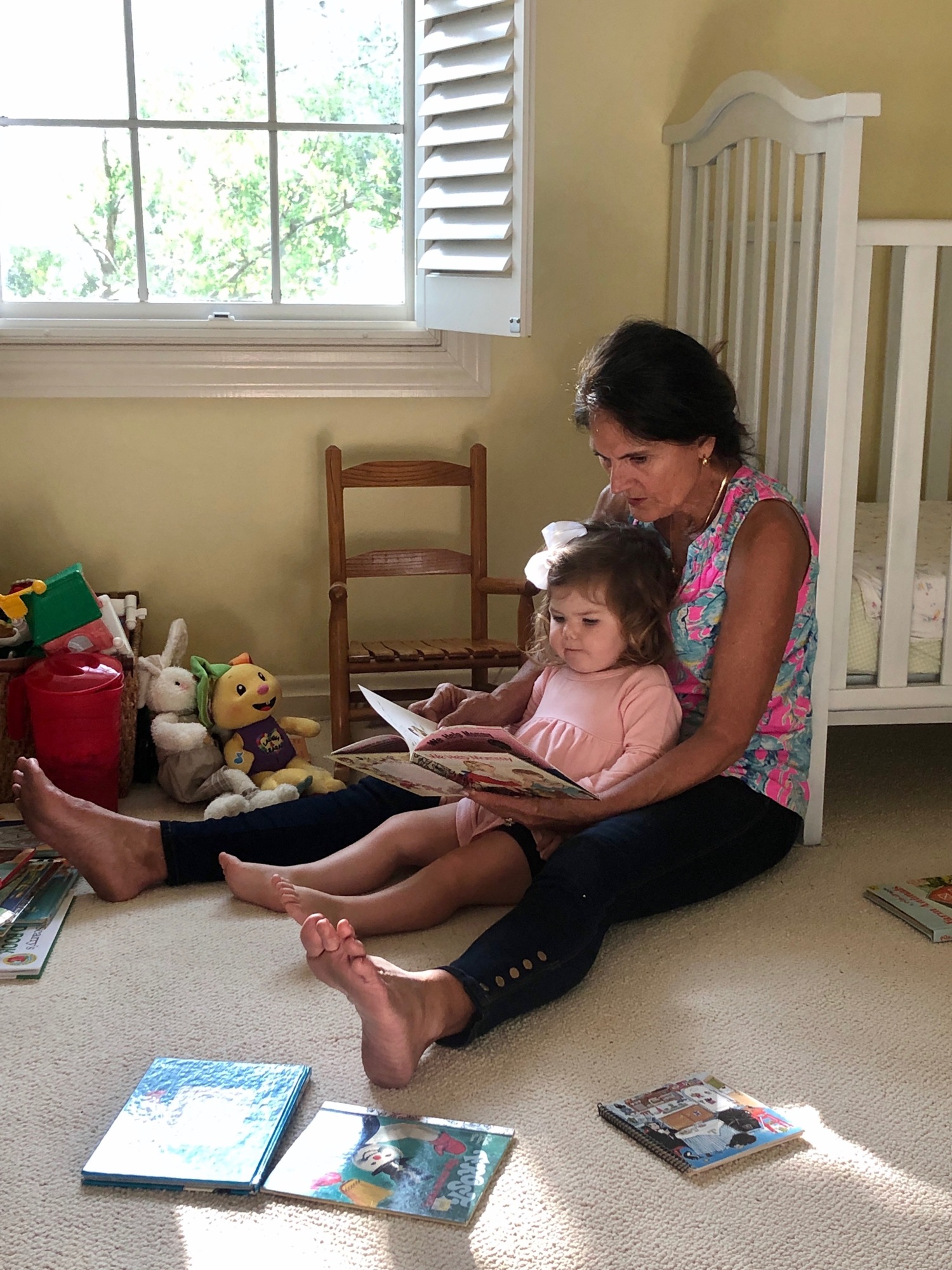 Mary Lou Johnson reads to granddaughter Lucy. Reading to her daughters was one of her favorite activities with her daughters and now she gets to do it with all four grandchildren.