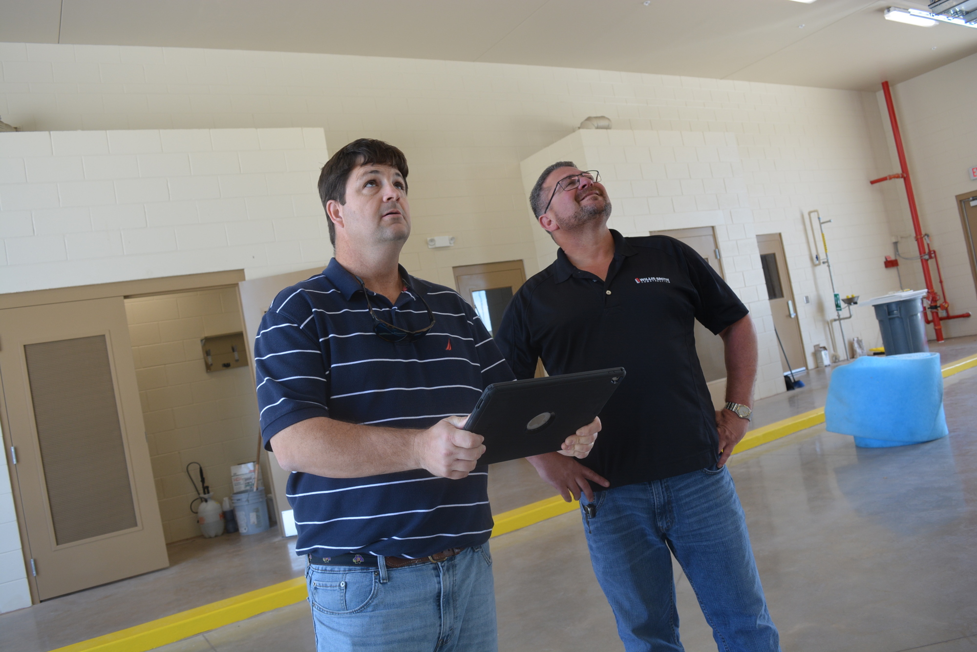 Willis A. Smith Construction project manager Aaron Simpson and superintendent Richard Powell look at their punch list for a final inspection May 8.