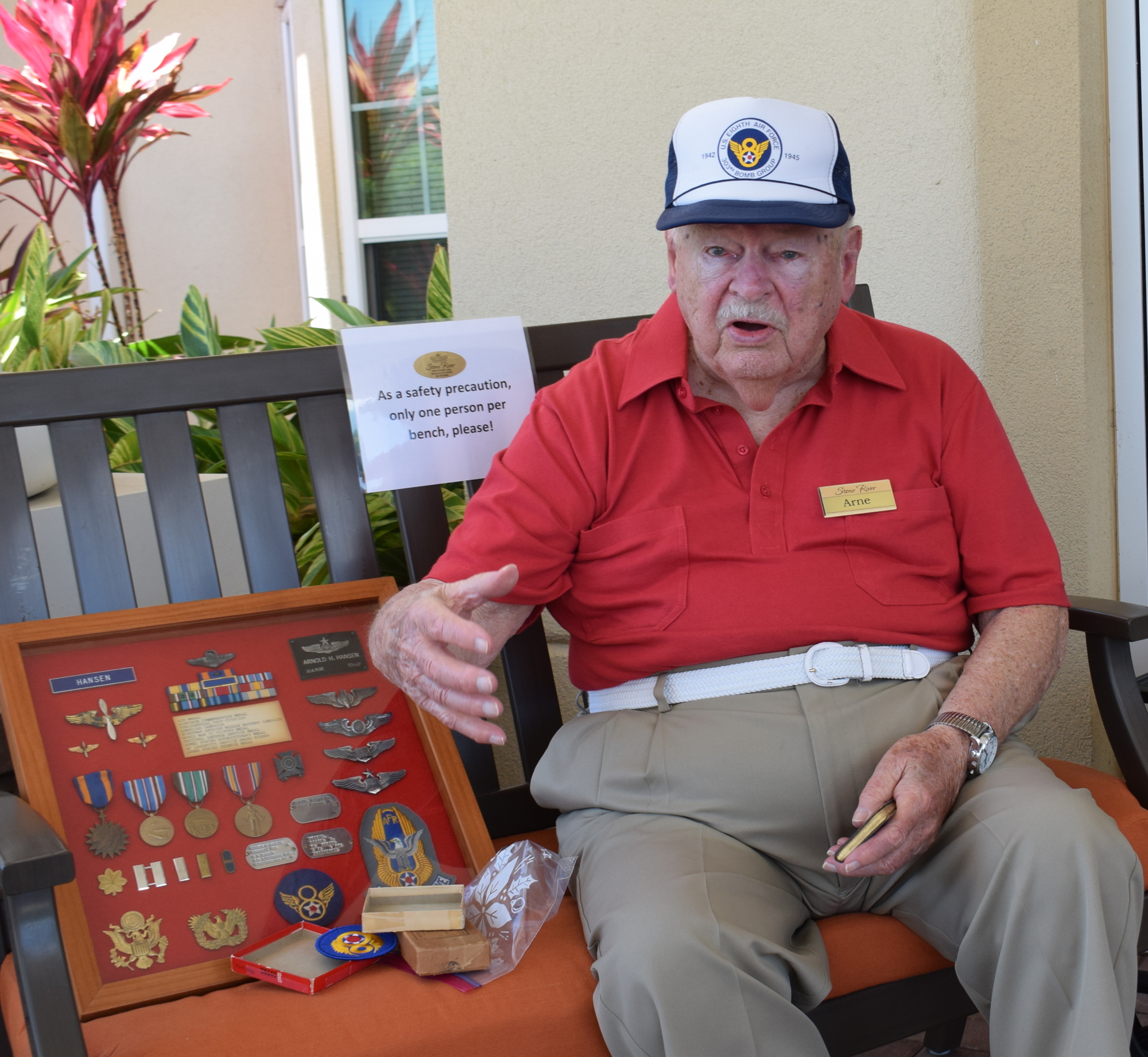 Arne Hansen sits outside of Stone River with some of the medals he earned during WWII.